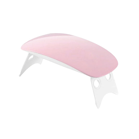 Hand under mini LED UV nail lamp