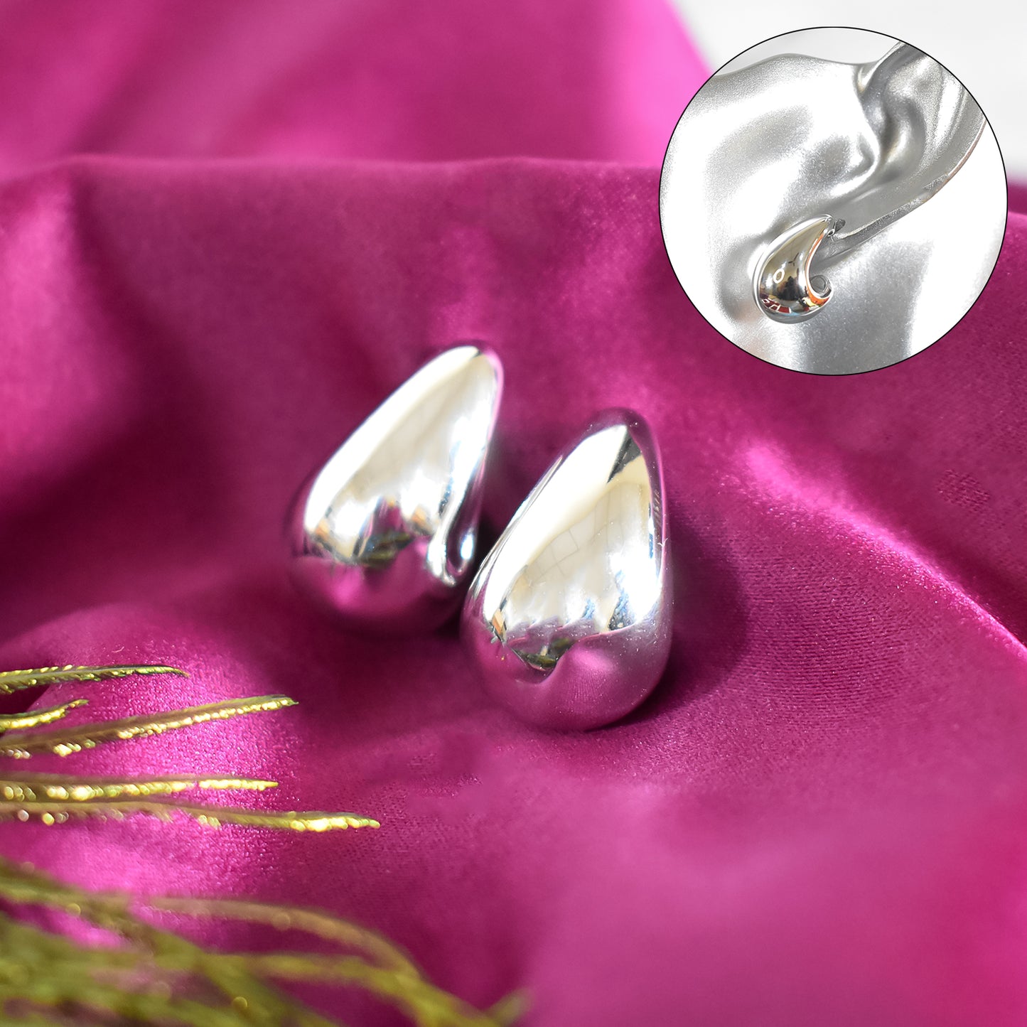 Pair of polished Kaju design earrings arranged neatly, emphasizing their timeless appeal.