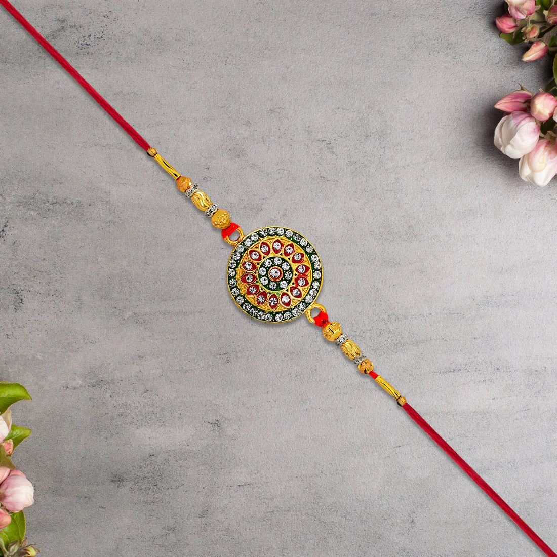 Kundan Rakhi displayed with traditional roli and chawal for Raksha Bandhan rituals.