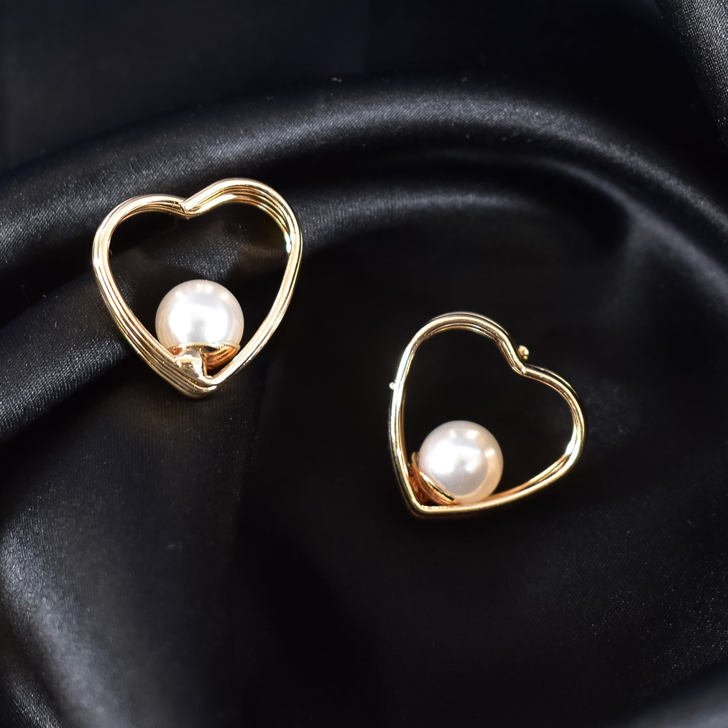 Close-up of elegant sparkling stud earrings from the HV collection.