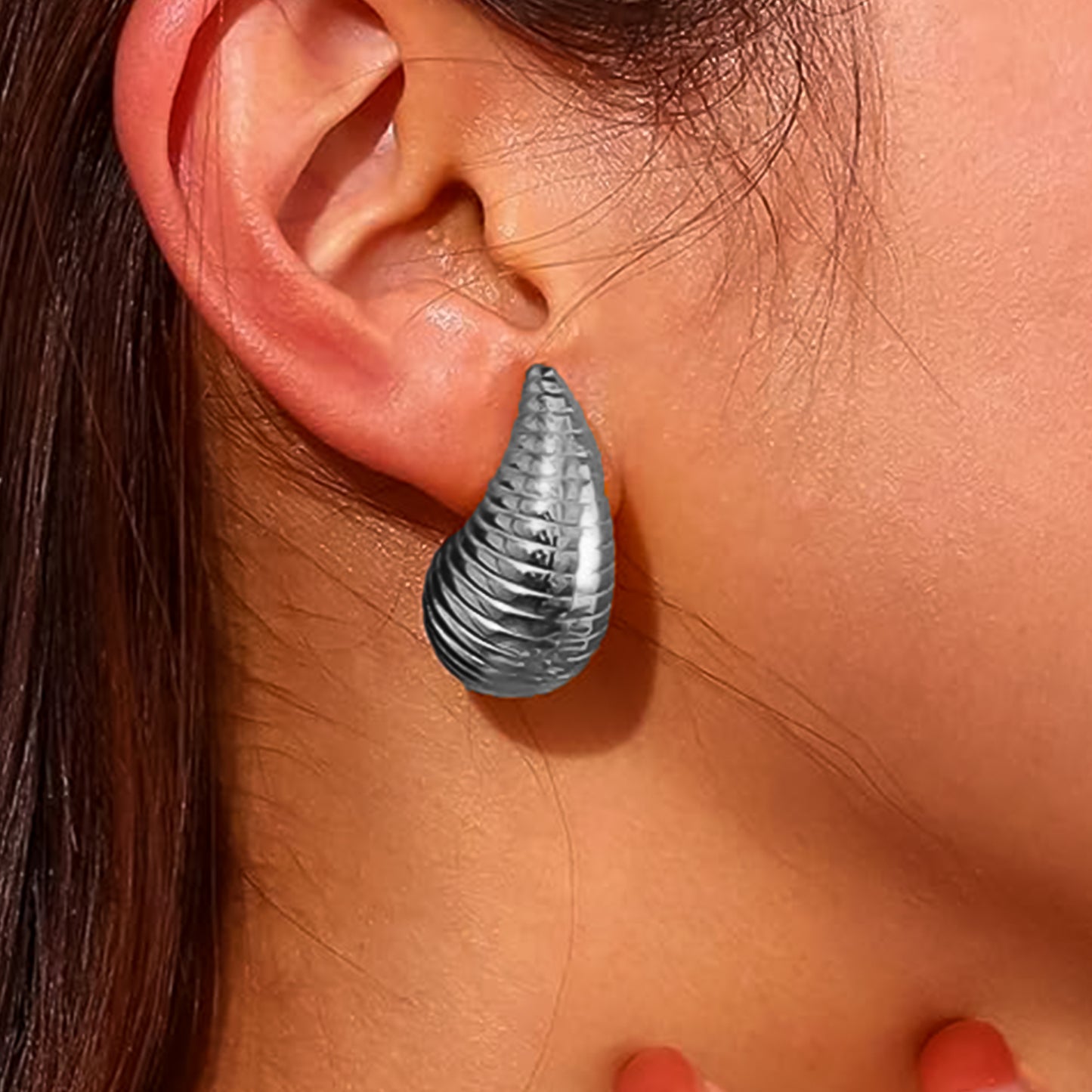 Close-up view of the intricate craftsmanship and polished finish of the glamorous Kaju earrings.