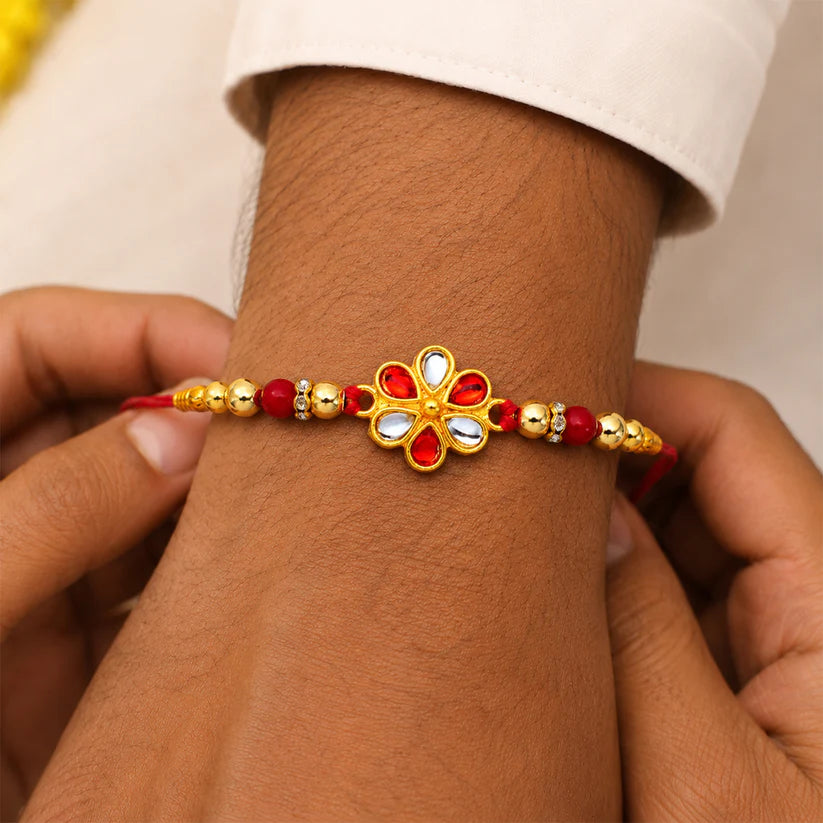Angled view of the Floral Rakhi showcasing its traditional beaded pattern.