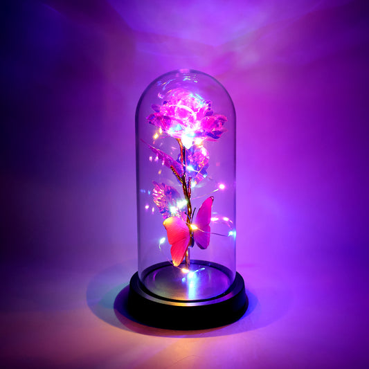 LED decorative rose with butterfly inside clear plastic dome glowing with warm lights