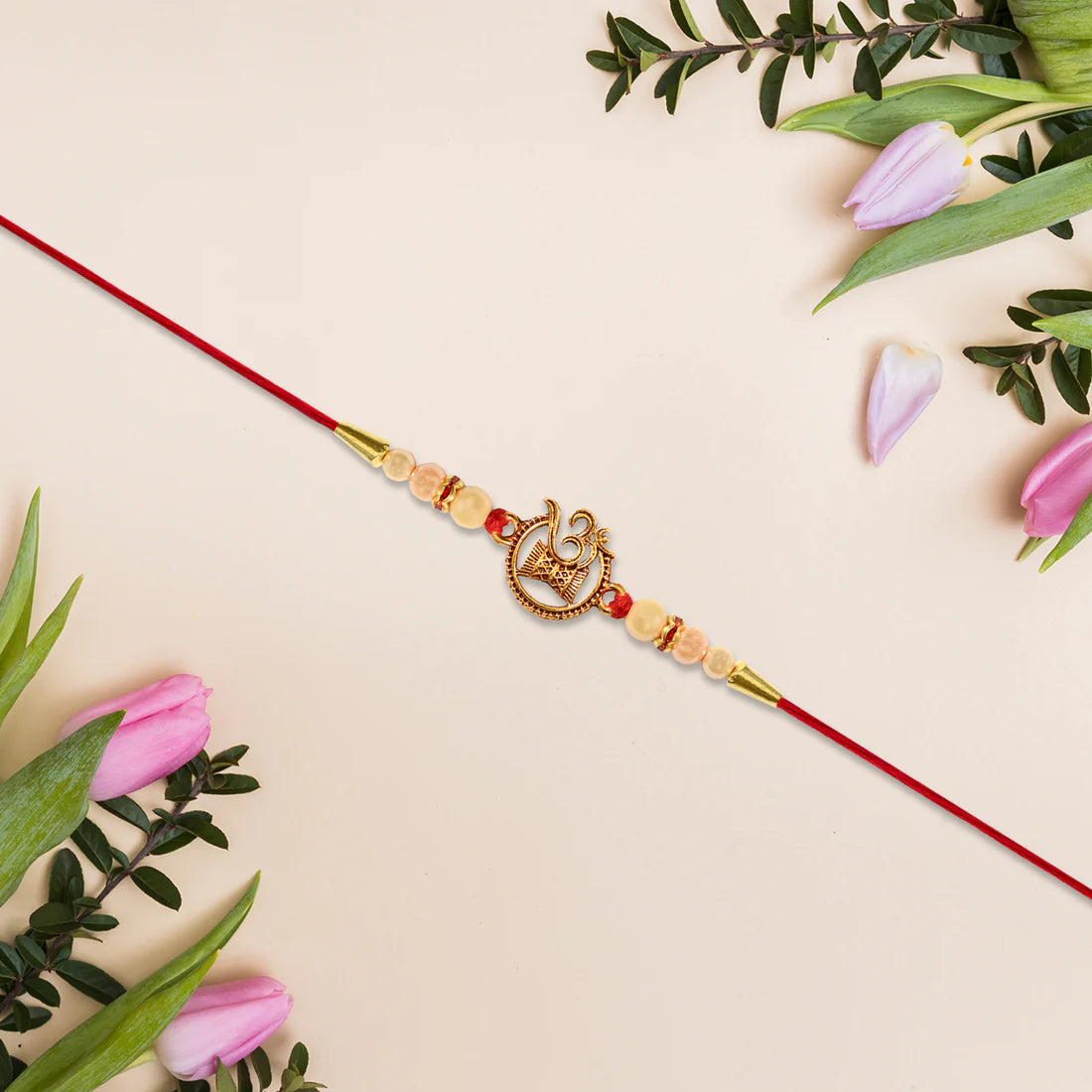 Om Swastik Rakhi – Golden Motif with Pearl Beads for Brother