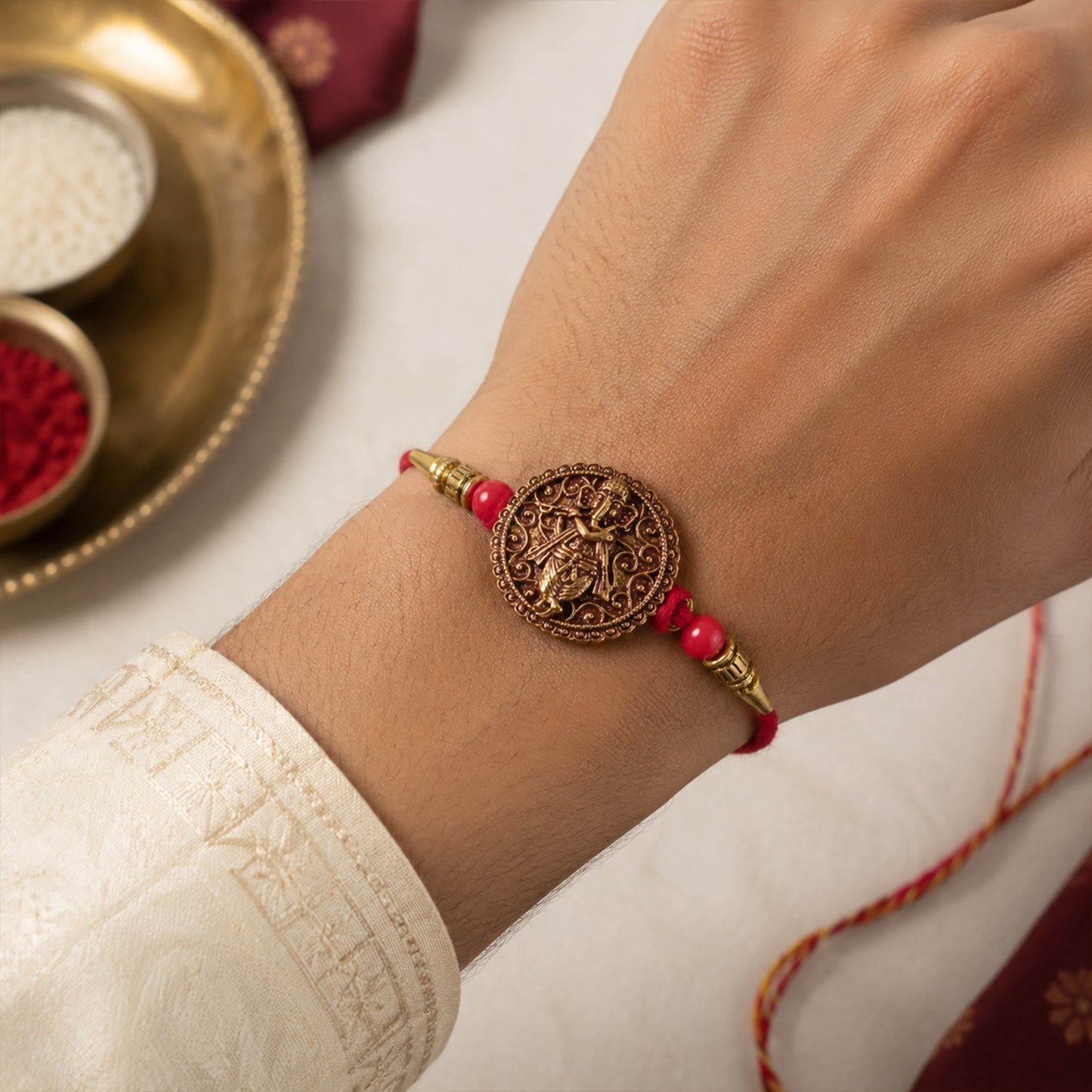 Ganesha Coin Rakhi – Antique Design with Red Beads