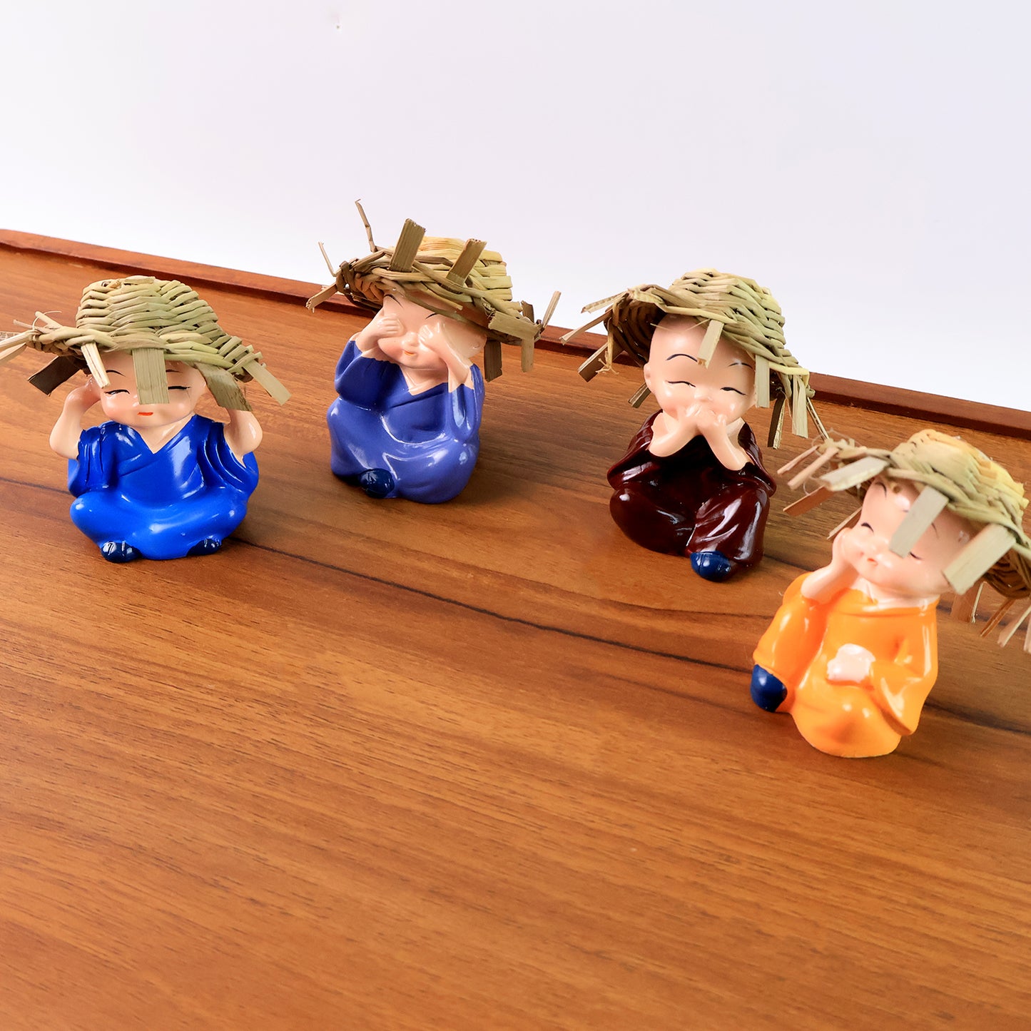 Decorative Resin Monk Buddha Showpiece Set of 4 with Traditional Straw Hats