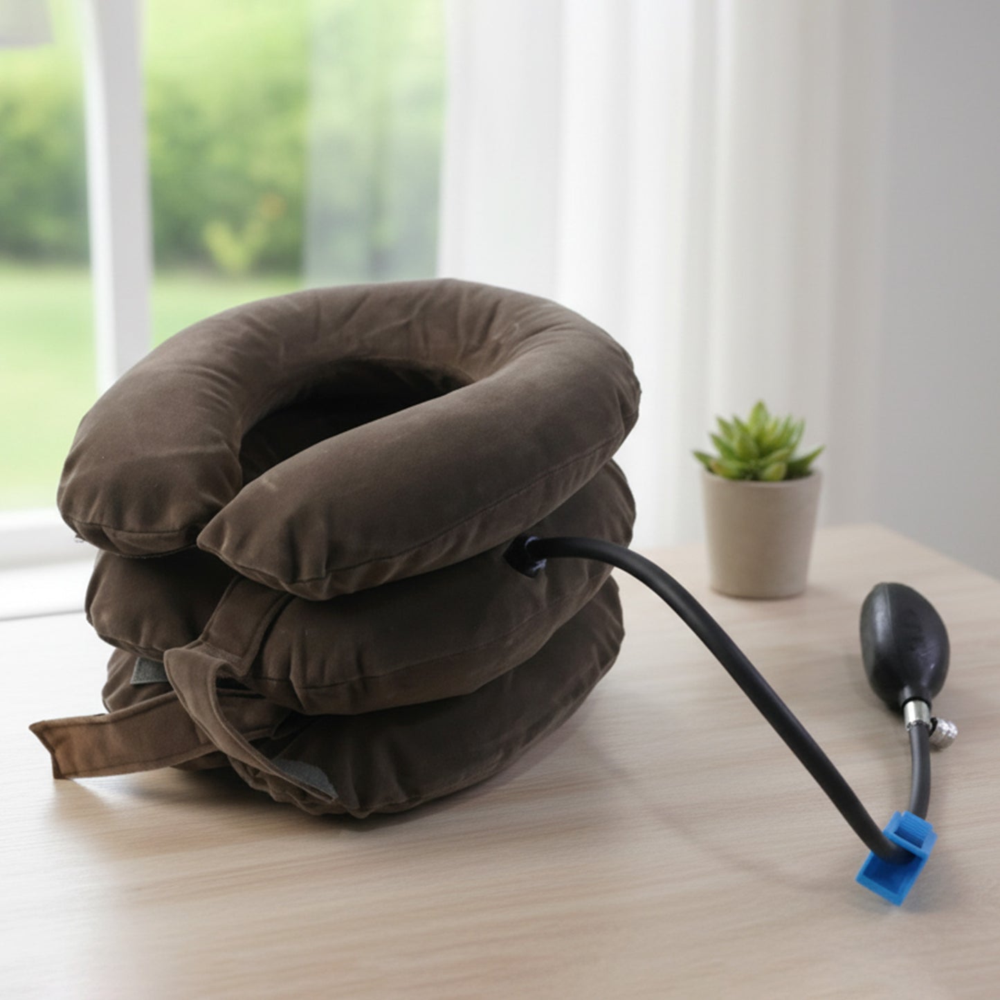 Inflatable cervical neck traction collar showing air pump connection