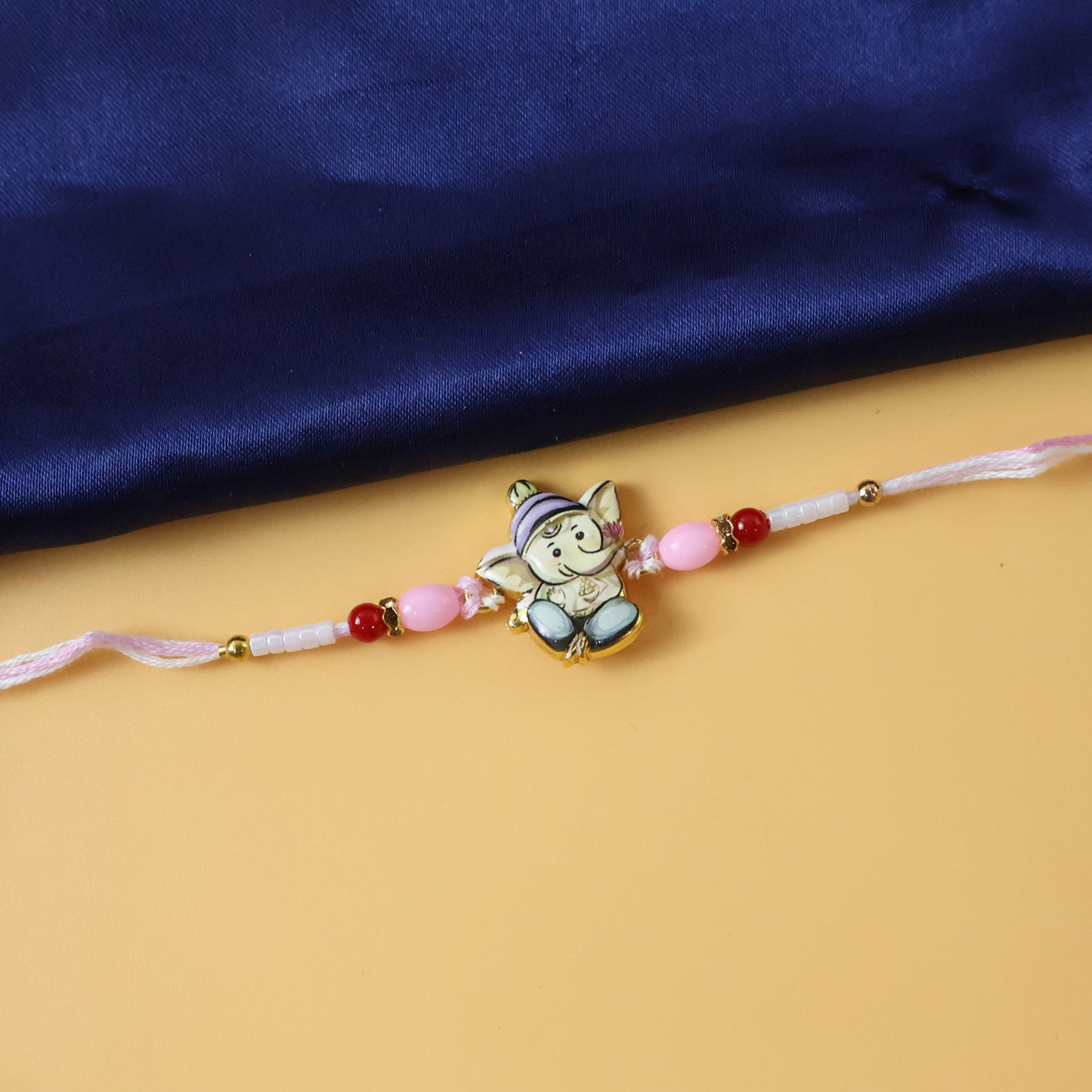 Cute Ganesha Designer Rakhi with Pink and Red Beads (1 Pc)