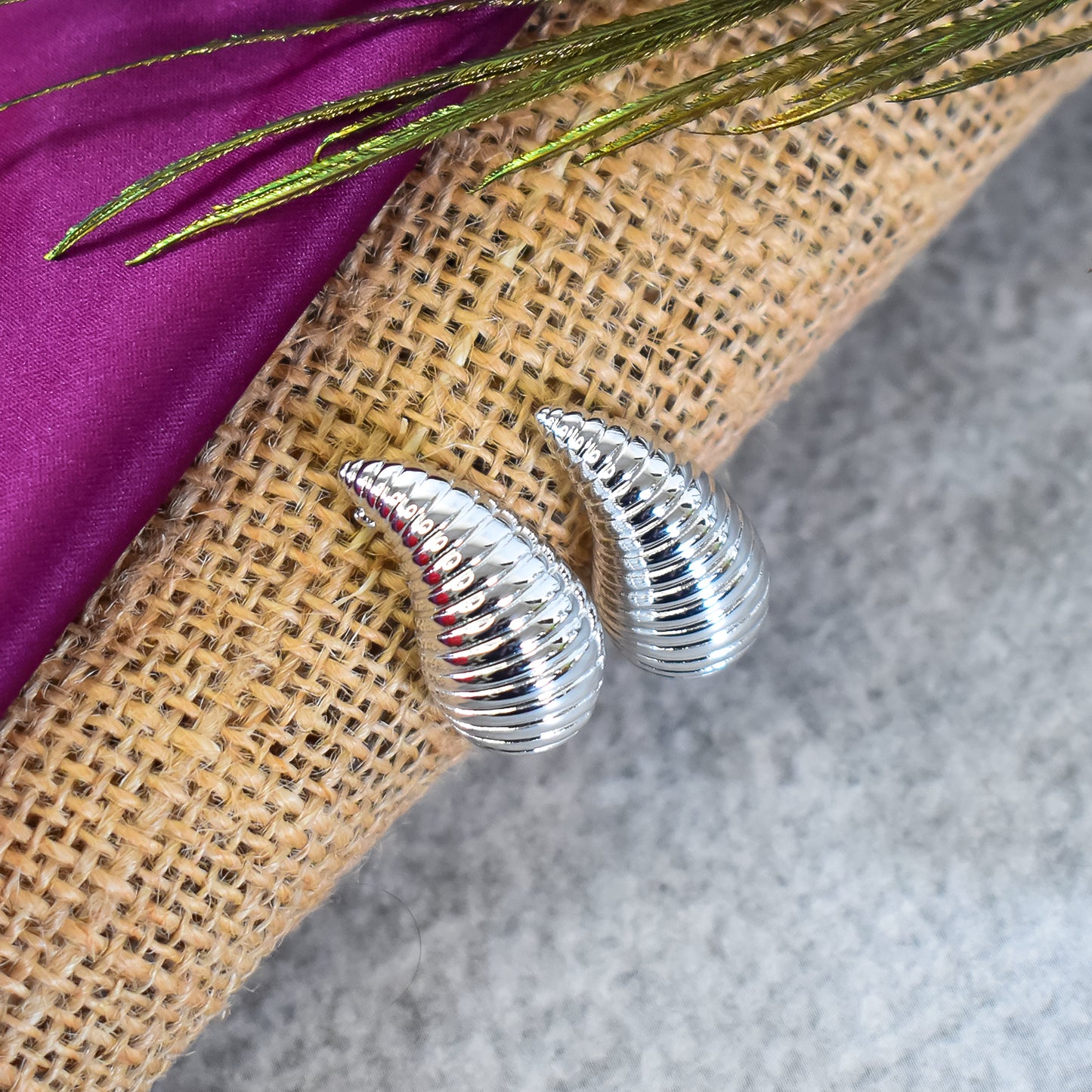 Elegant Kaju earrings with a detailed cashew-inspired design, displayed on a white background.