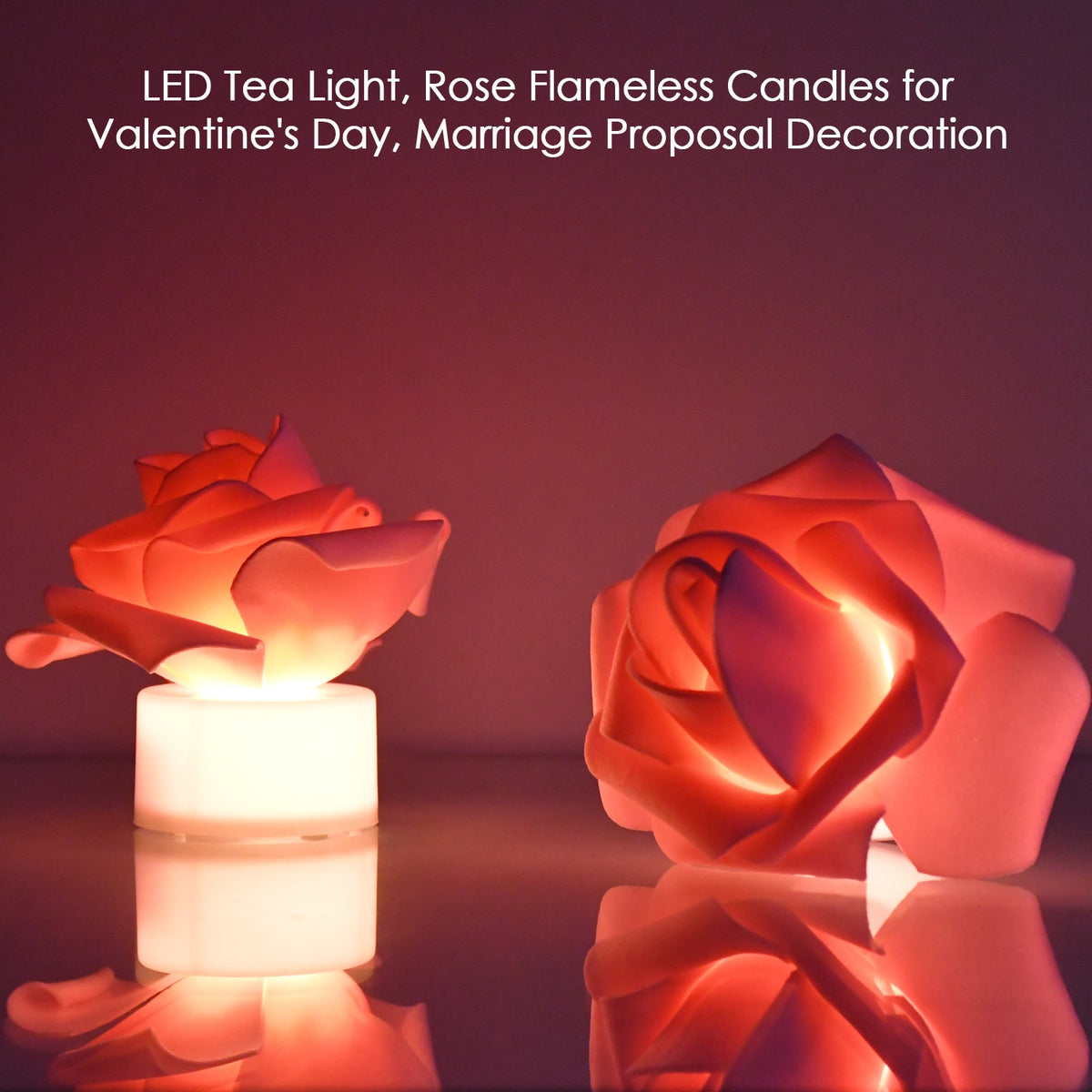Two rose LED tea lights with a soft orange glow reflect on a shiny surface against a dark background.