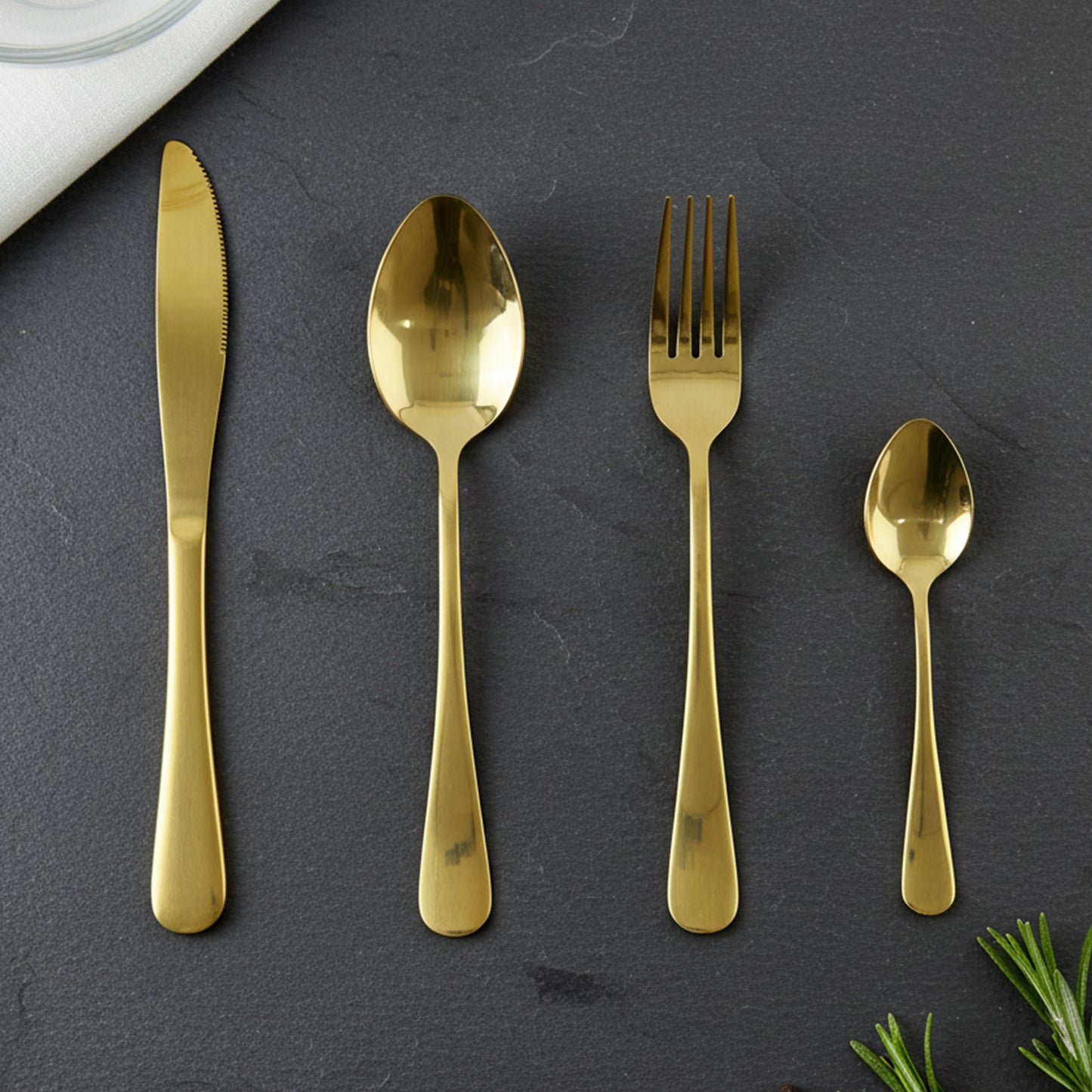 Gold cutlery pieces laid out