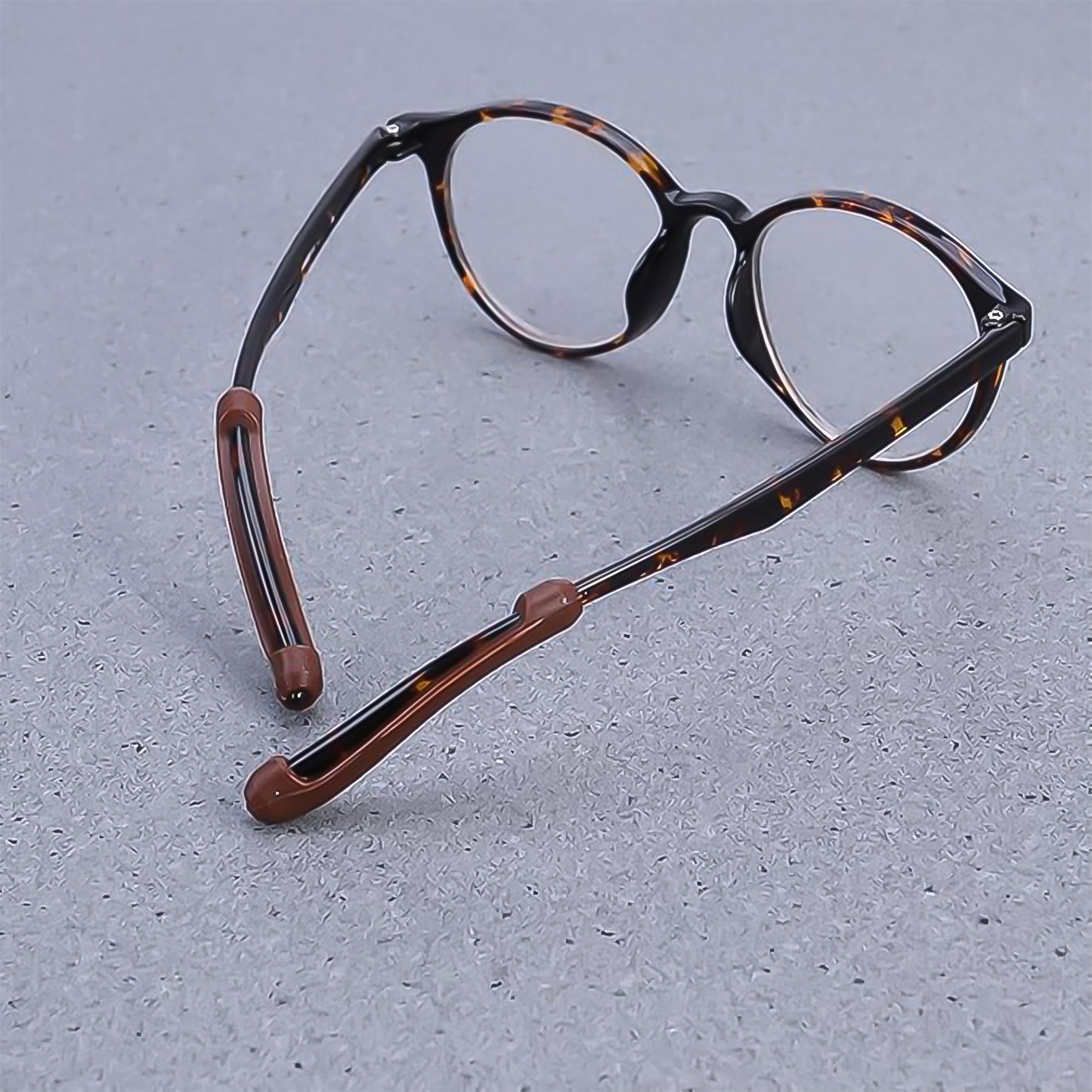 Silicone grips attached on eyeglass arms preventing slipping