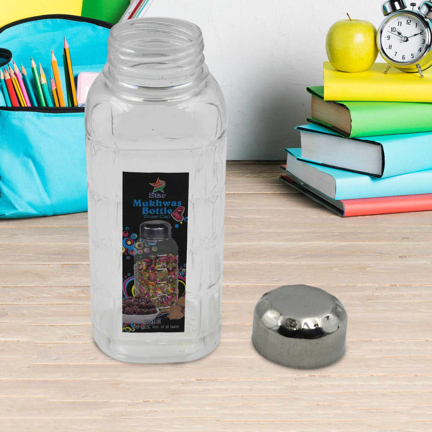 Plastic mukhwas bottle next to dry fruits bowl