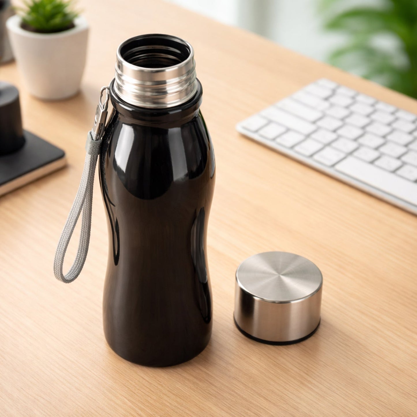 Portable stainless steel water bottle in backpack holder