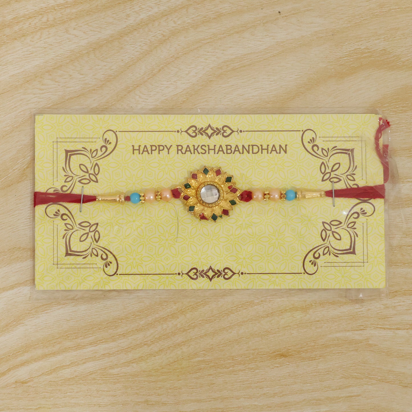 The Floral Mirror Rakhi presented in a gift box, ready for Raksha Bandhan.