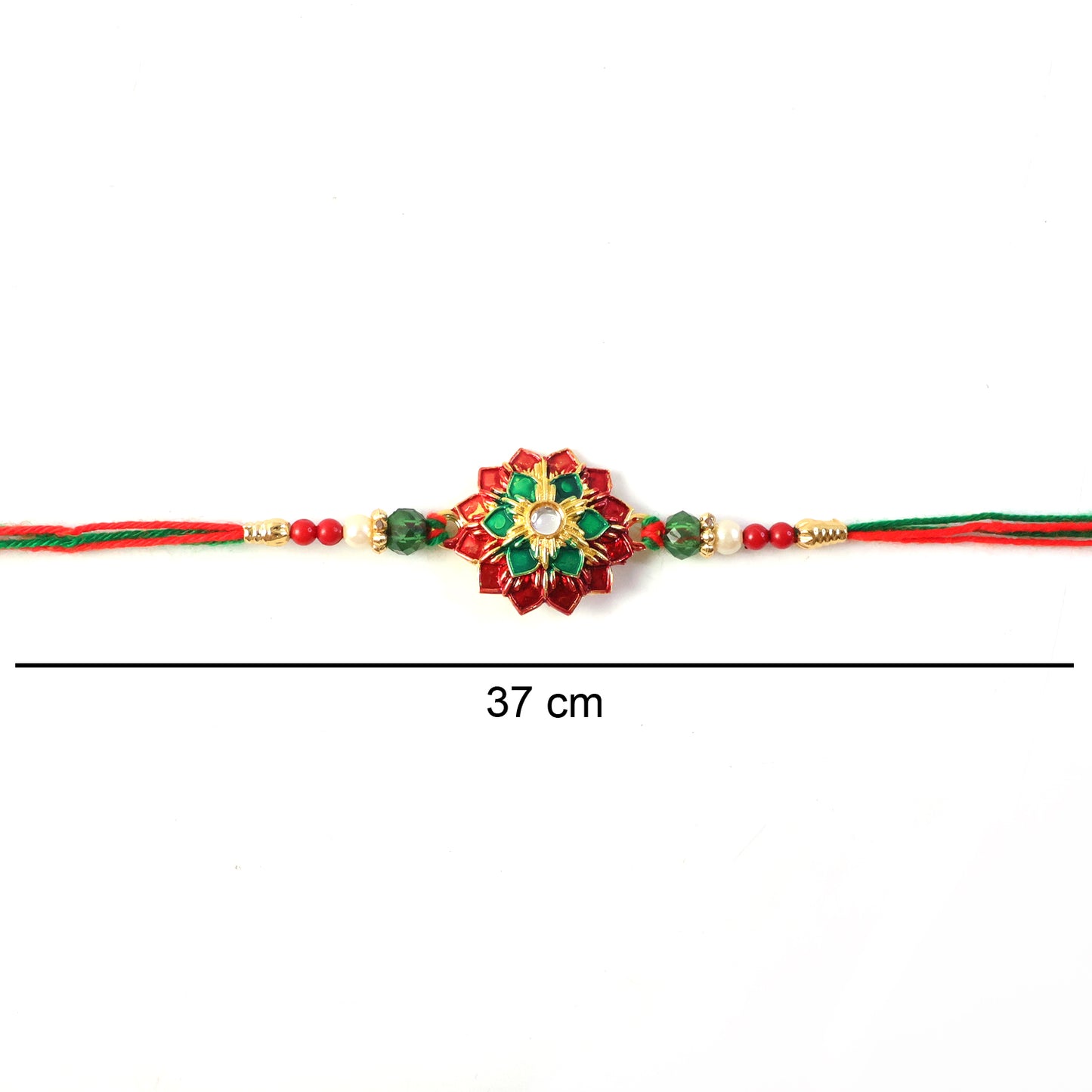 Hand holding floral stone work Rakhi with colorful thread