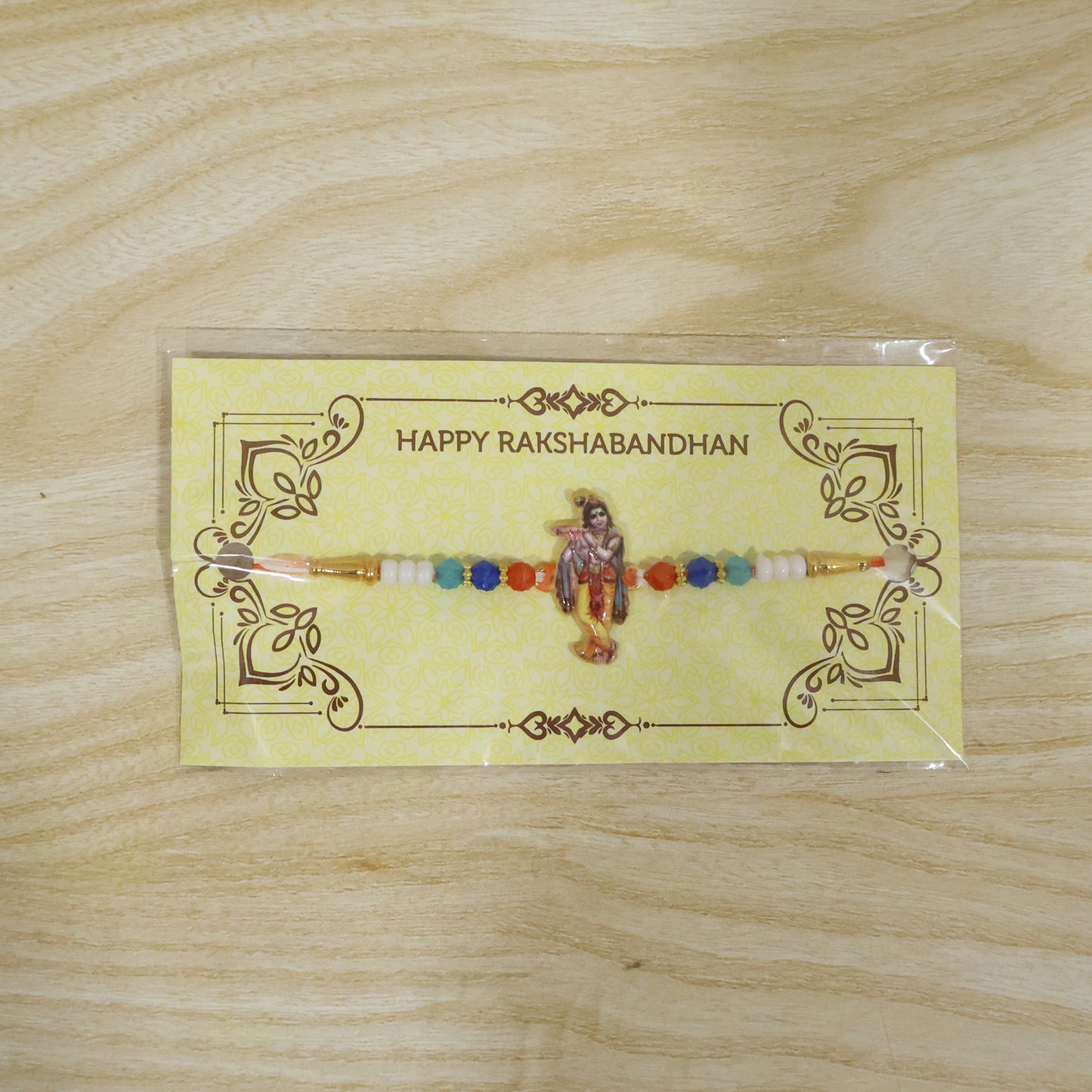 Spiritual Designer Rakhi with Lord Krishna Flute Playing Idol (1 Pc)