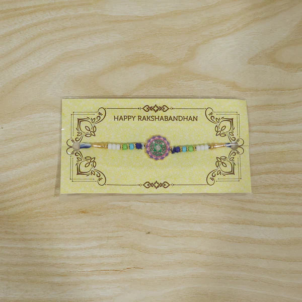 Top down view of the floral stone Rakhi highlighting its traditional design.