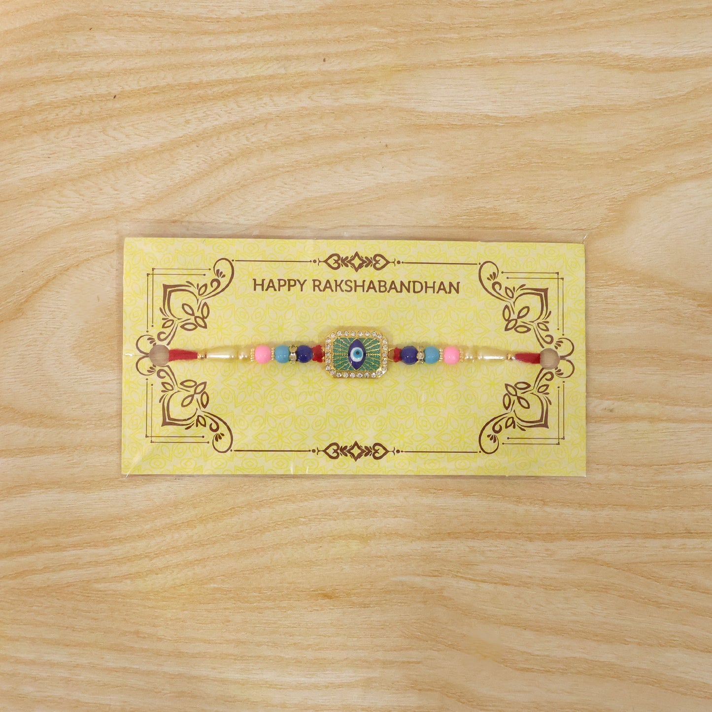 Elegant mint green thread Rakhi with decorative beads