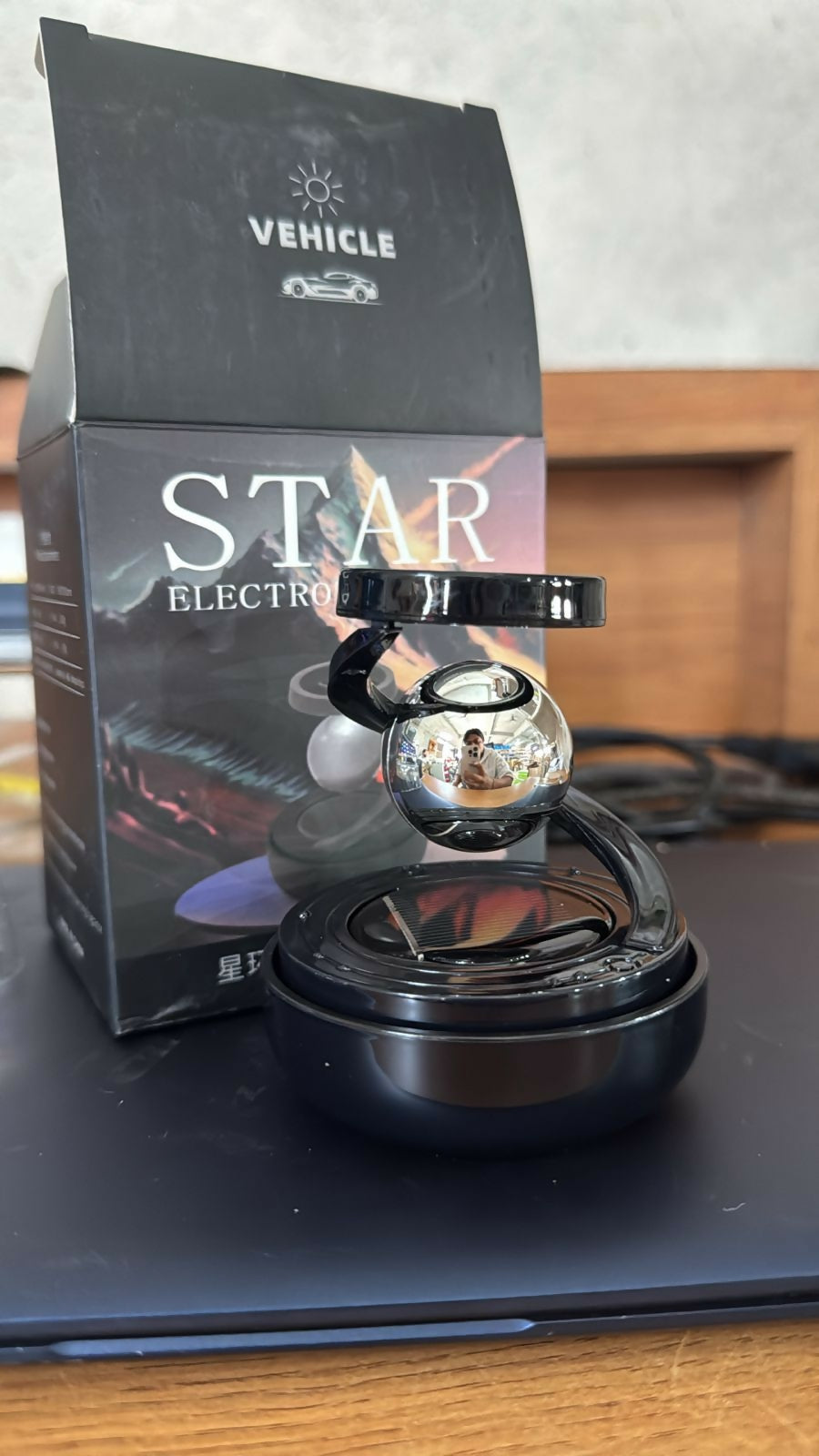 Elegant black rotating car air freshener placed inside vehicle