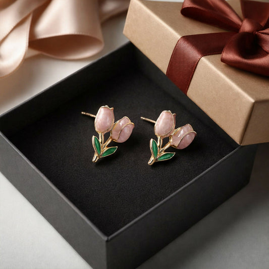 Pink tulip flower stud earrings with green leaf accents on white background