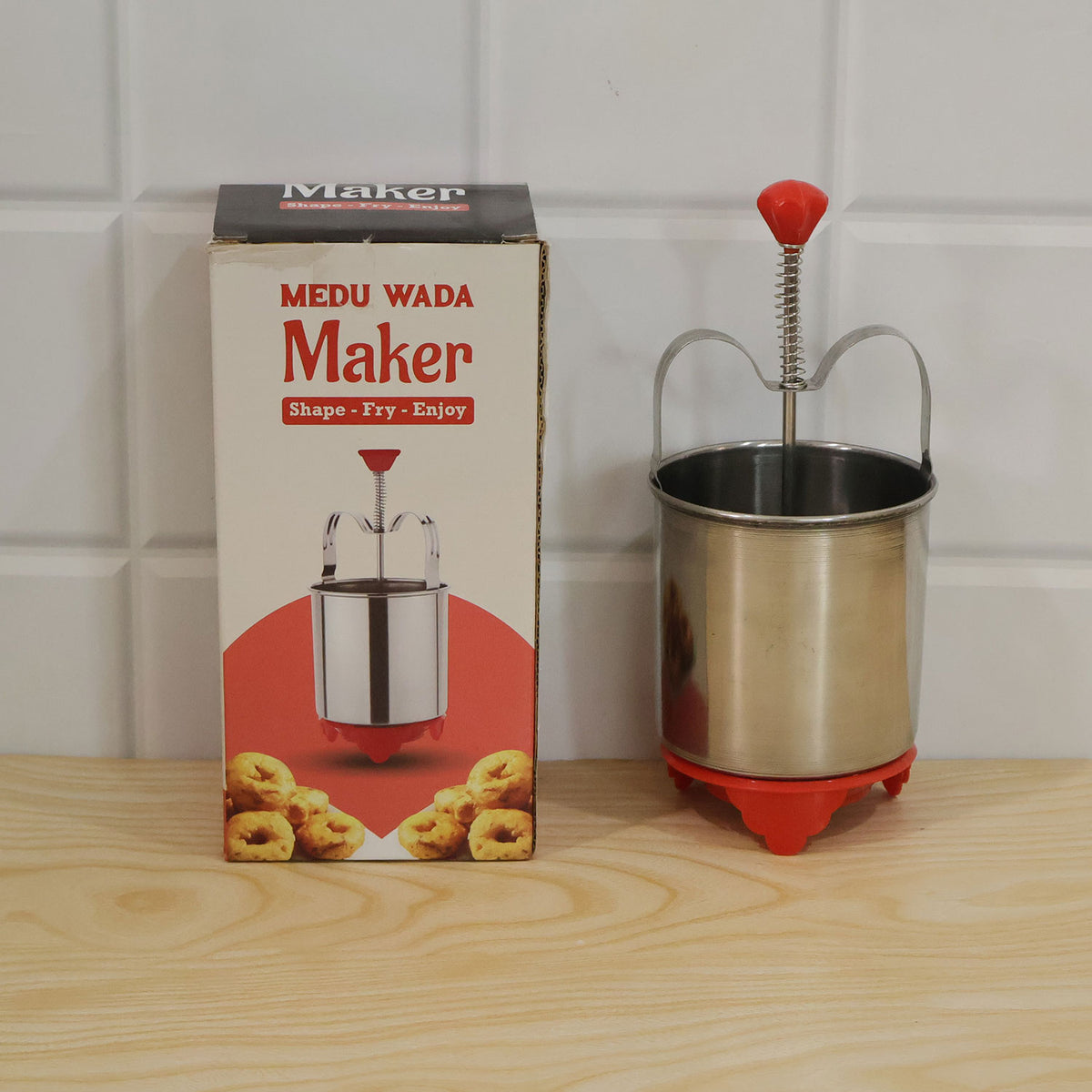 Packaging of the CookAura Medu Wada Maker, emphasizing its branding.