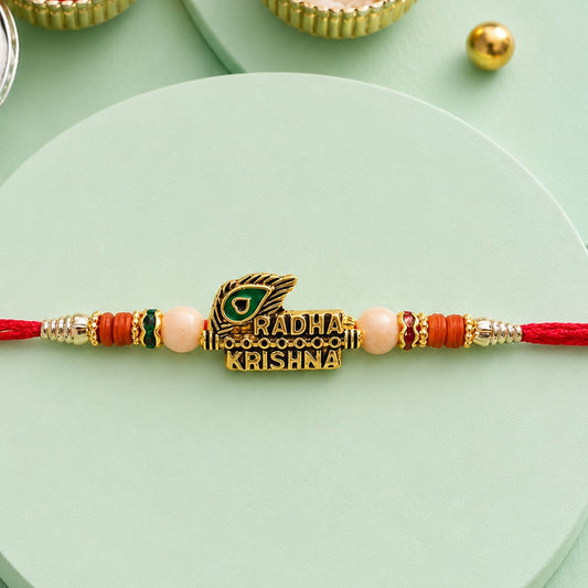 Radha Krishna Peacock Feather Rakhi with vibrant beads and gold tone finish.