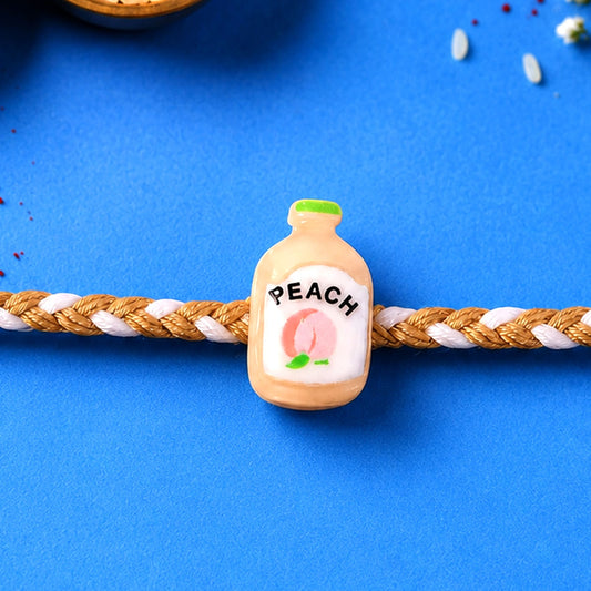 Peach Bottle Charm Rakhi for brother, showcasing its festive design