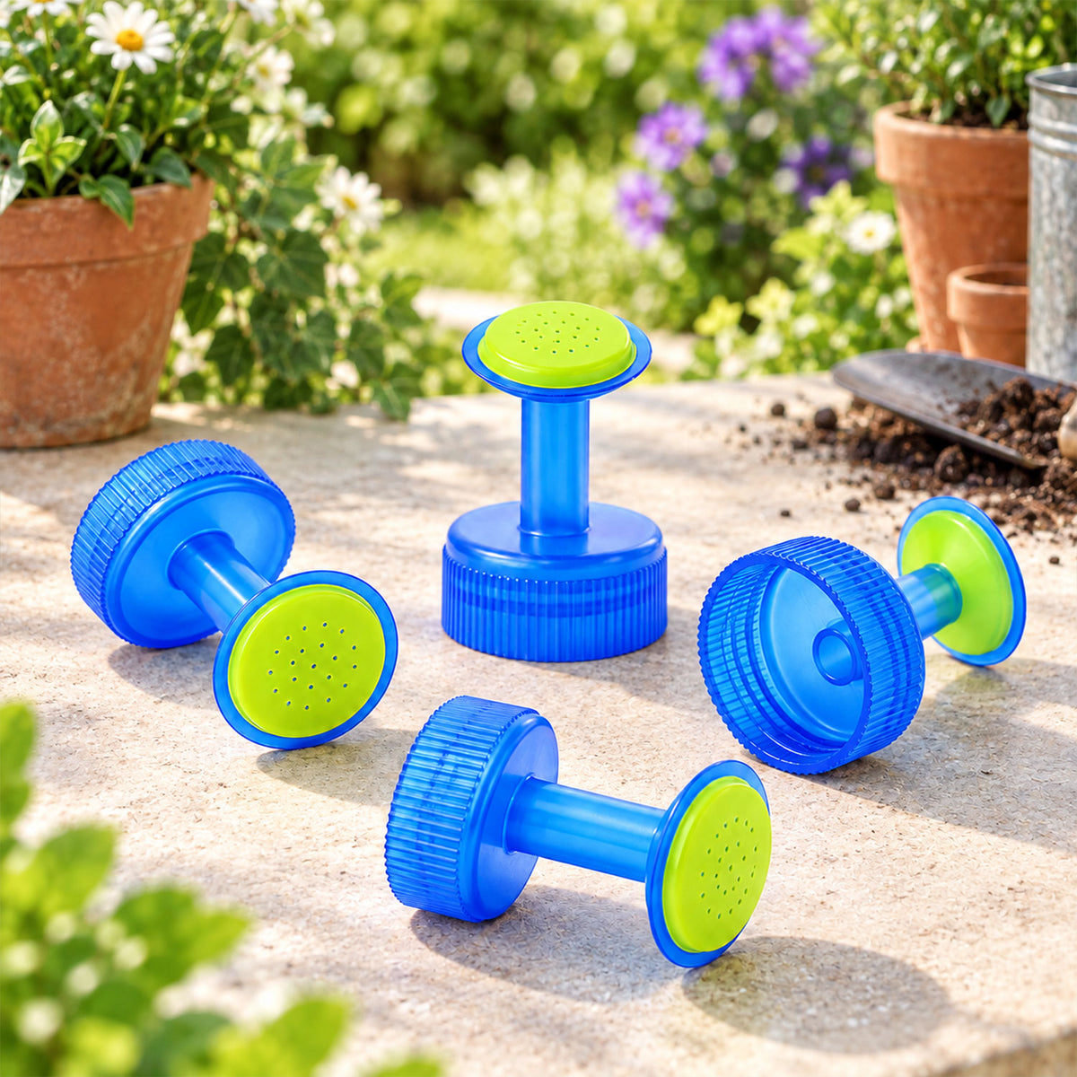 Four watering caps arranged beside garden pots