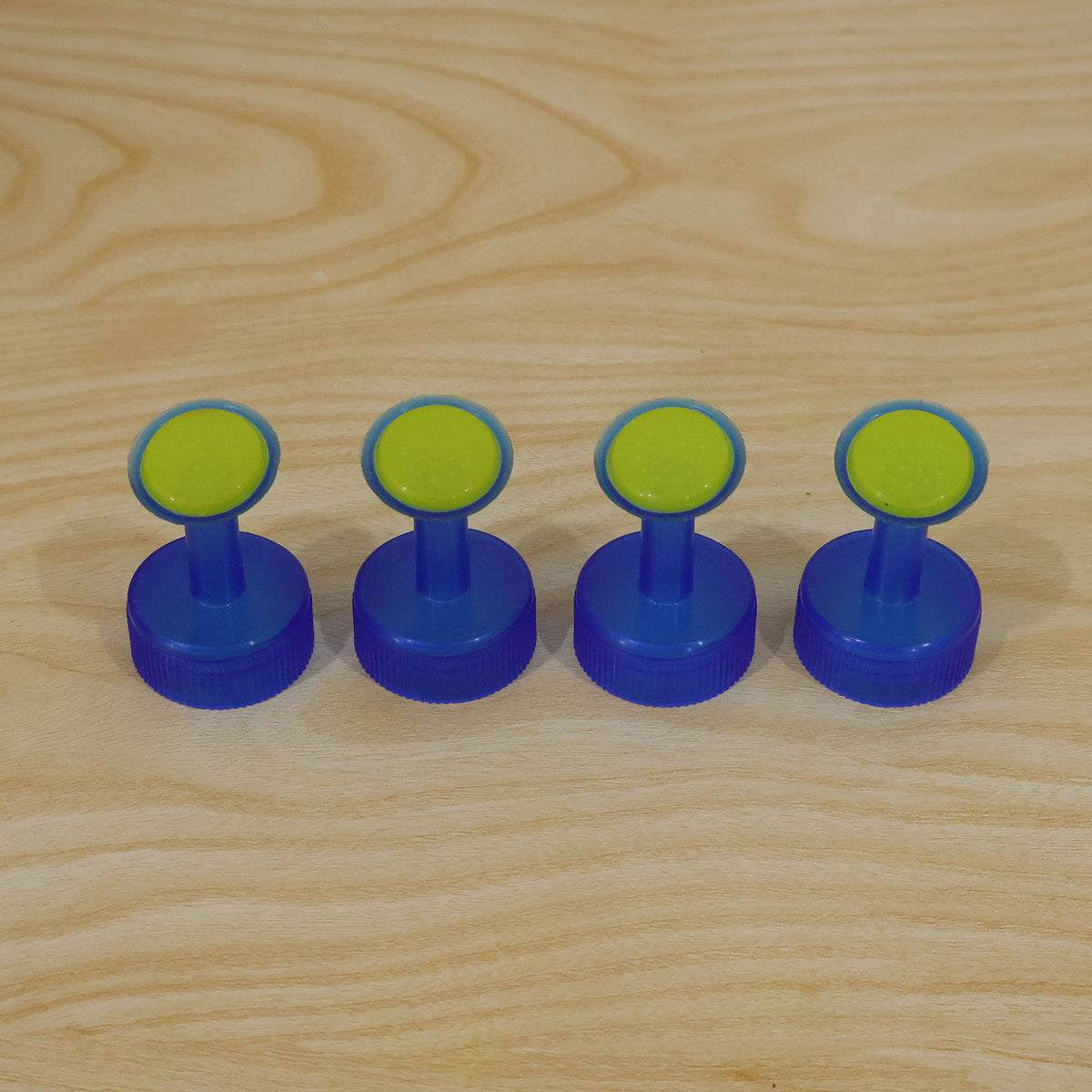 Actual photograph of four sprinkler bottle caps