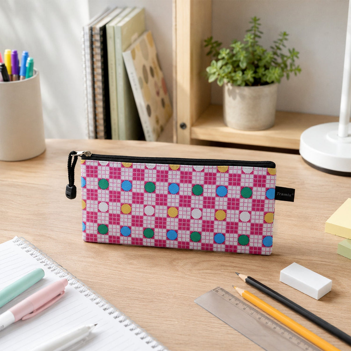 Different angles showing the vibrant print and zipper of the pouch