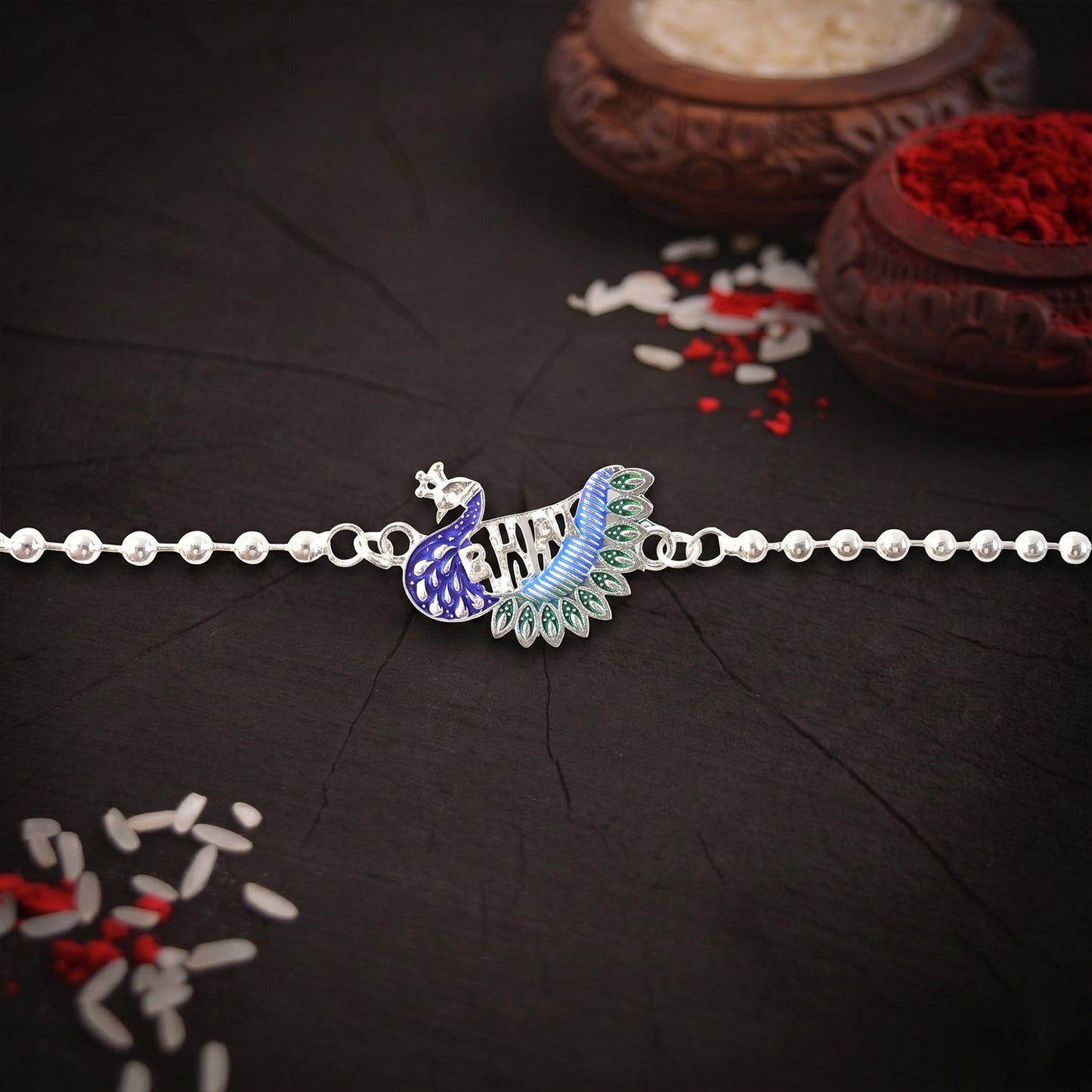 Silver finish peacock design Rakhi with beaded chain thread
