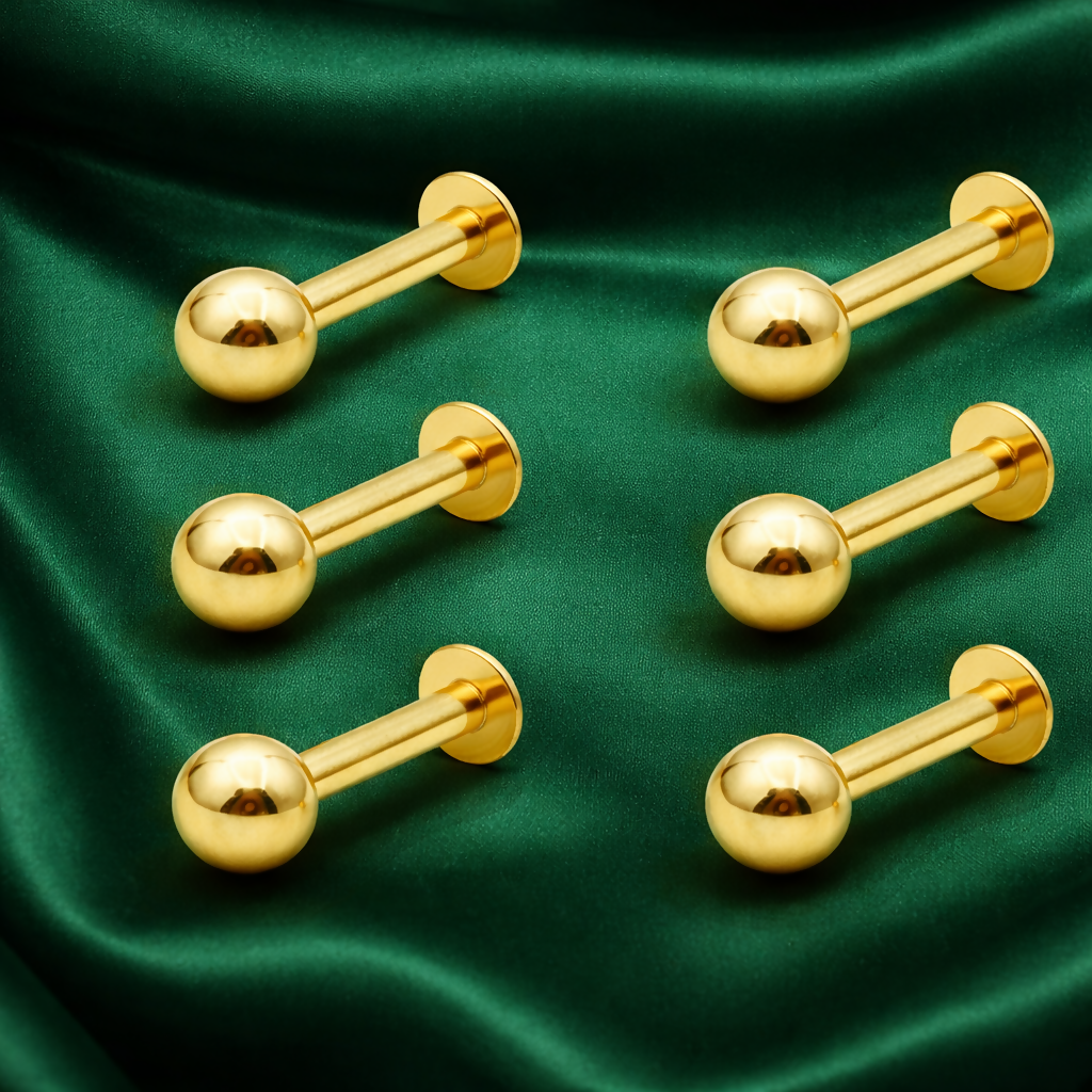 Close-up of gold nosepin stud with screw ball closure enhancing security.
