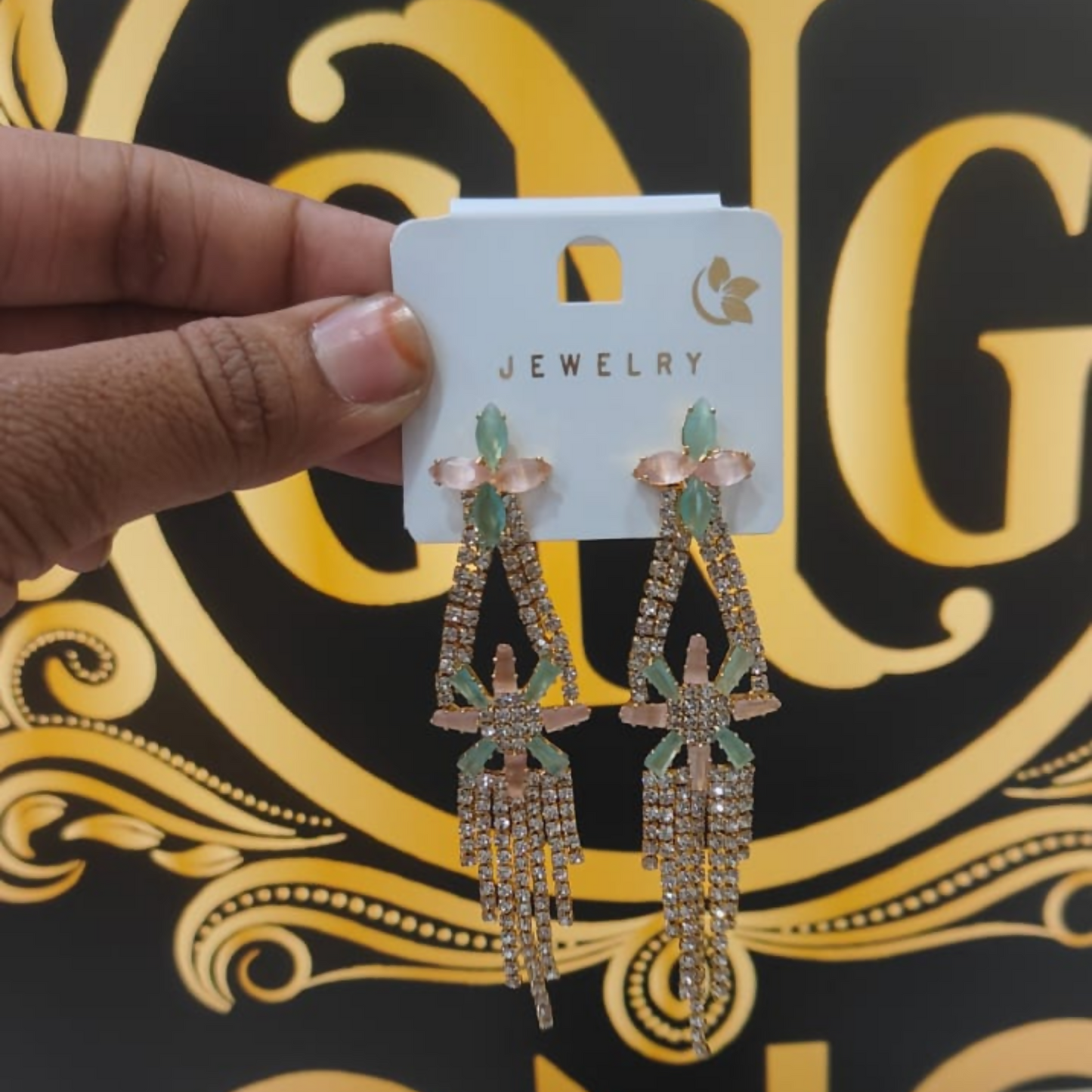 Side view of pastel floral crystal earrings showing intricate design