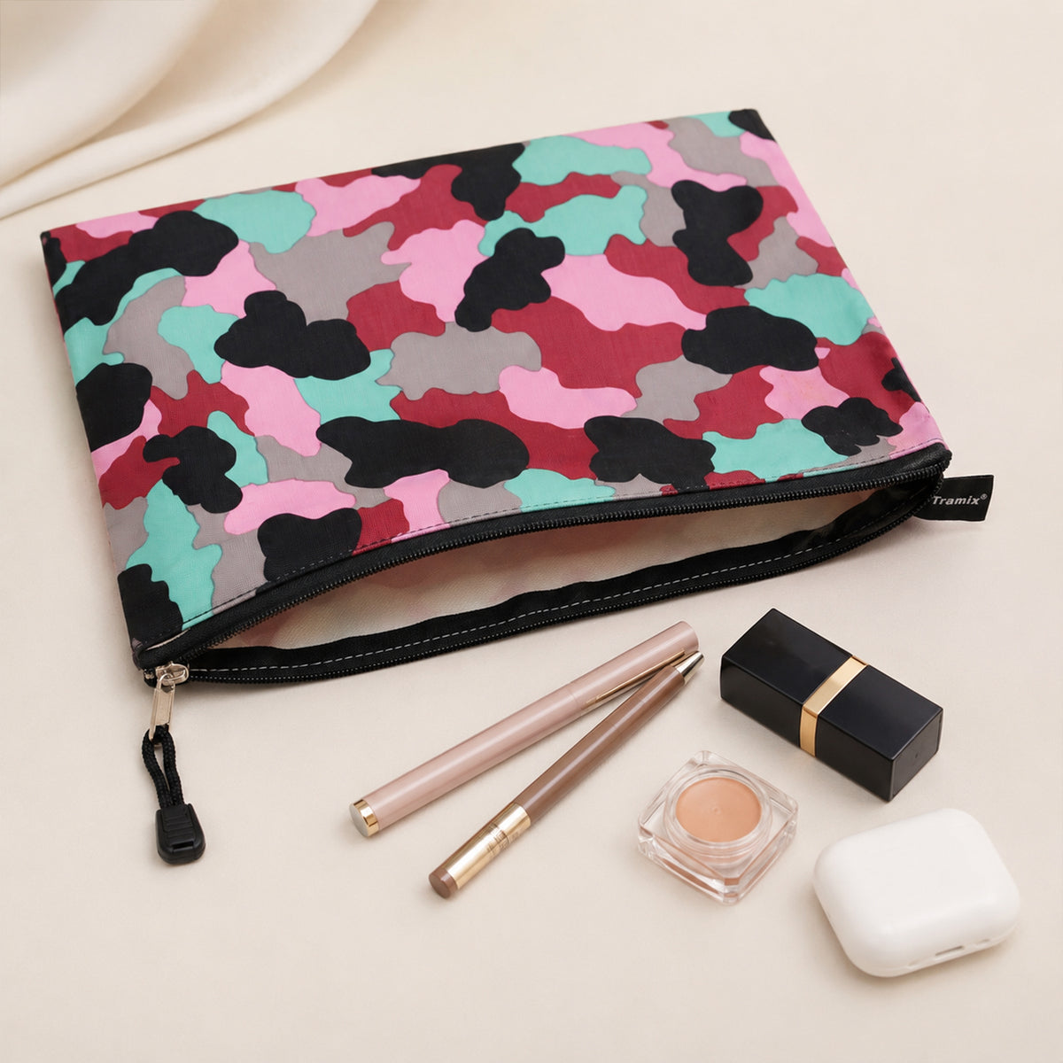 Open printed zipper pouch with makeup and everyday accessories