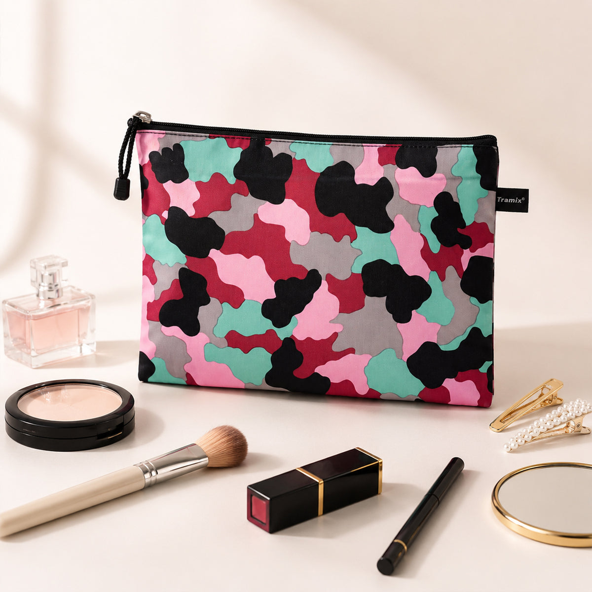 Printed zipper pouch displayed with cosmetics and accessories