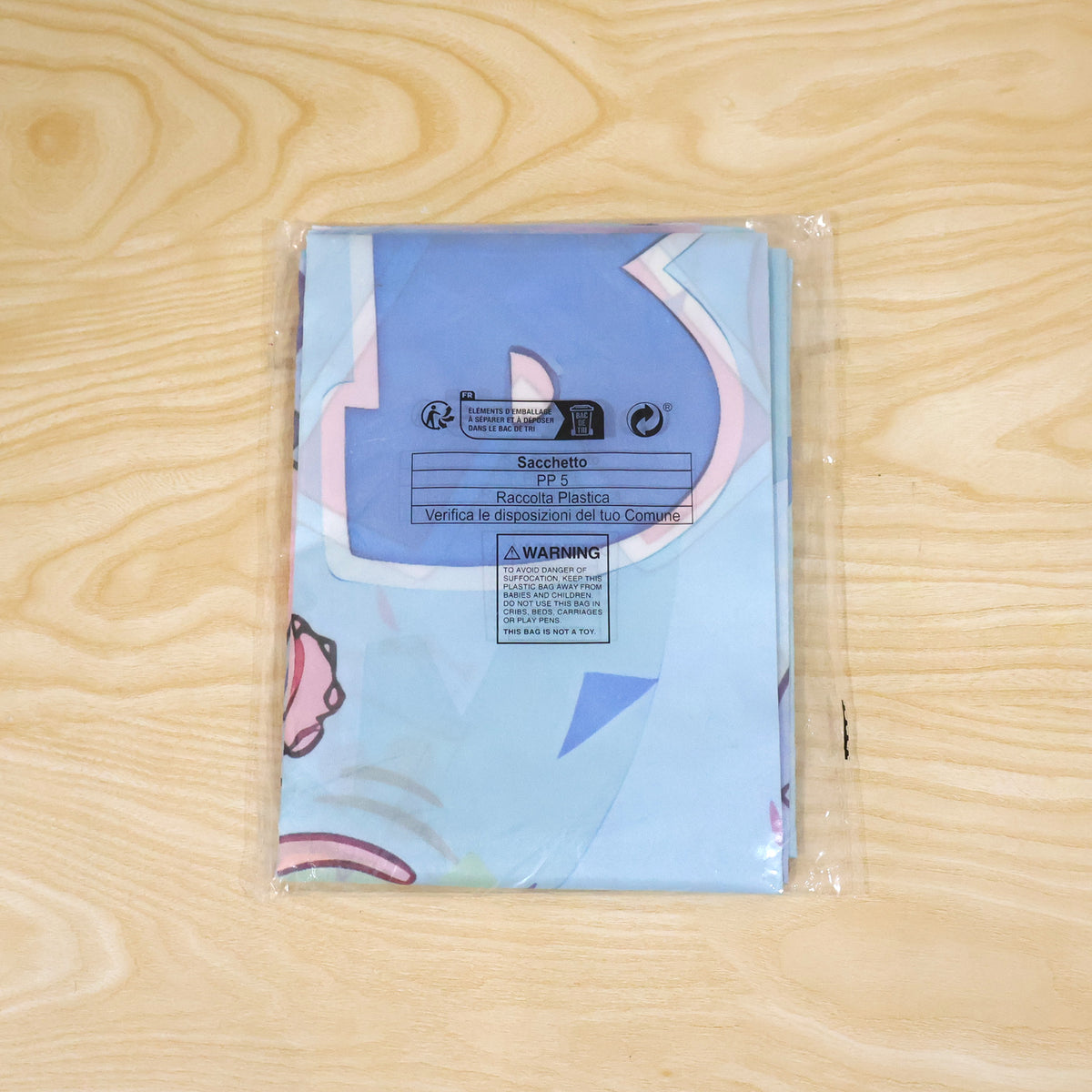 Actual photograph of folded birthday banner in plastic packaging