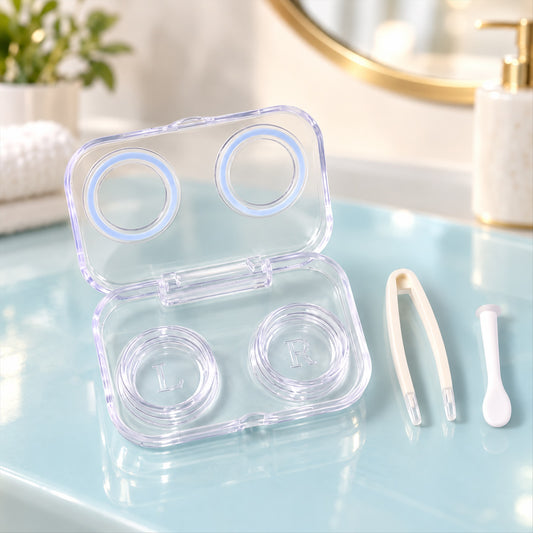 An open, clear plastic contact lens case with two containers marked L and R, alongside white tweezers and an applicator on a