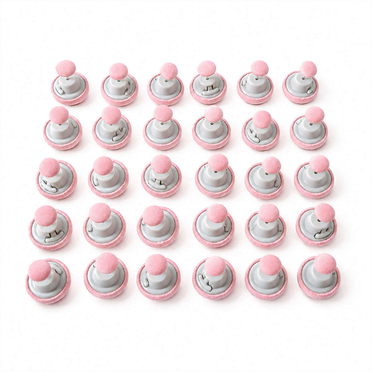 Fabric-covered duvet fastener button set on white background