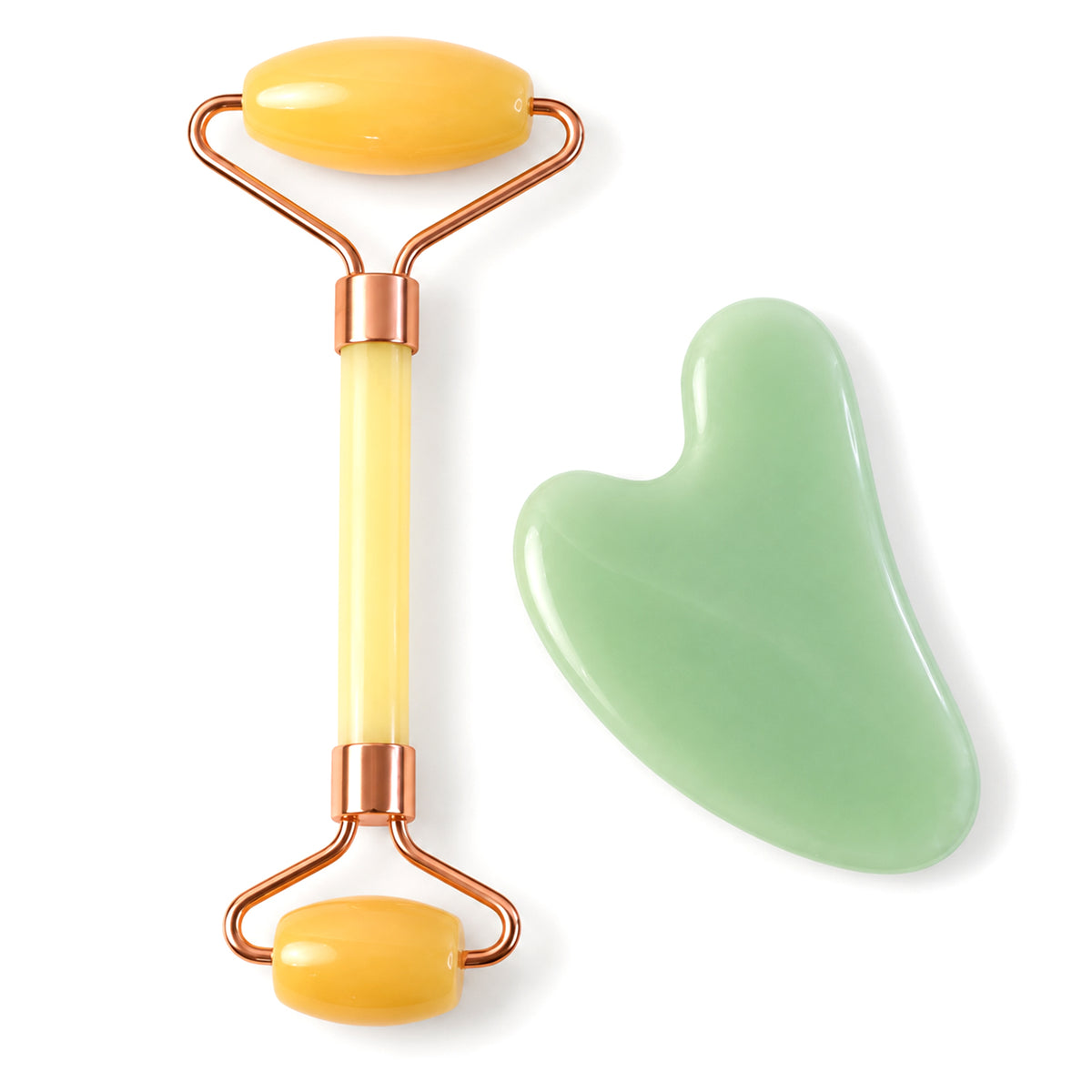 Facial roller and gua sha on white background