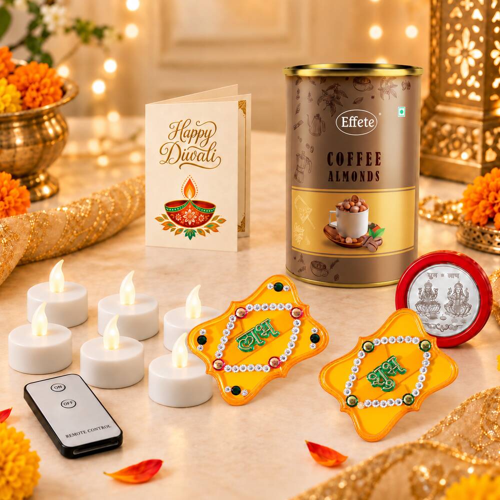 A close-up of a festive Diwali arrangement with a tin of coffee almonds, a greeting card, six LED tealights, a remote, two