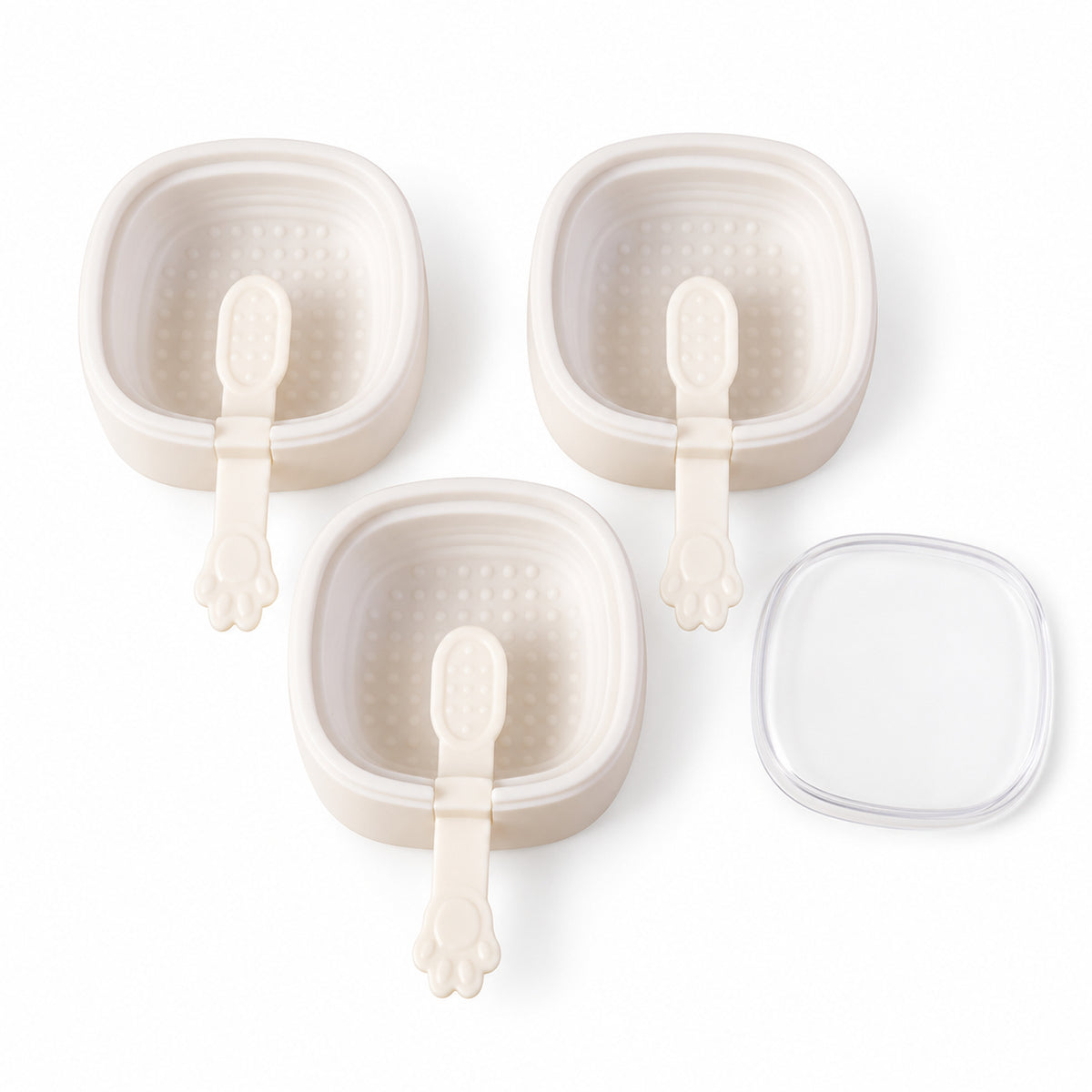 Three empty square molds with paw handles and a clear lid, arranged neatly on a white background.