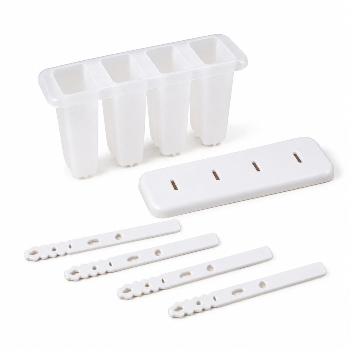 A white 4-cavity popsicle mold, its lid, and four individual white sticks are neatly arranged on a plain white surface.