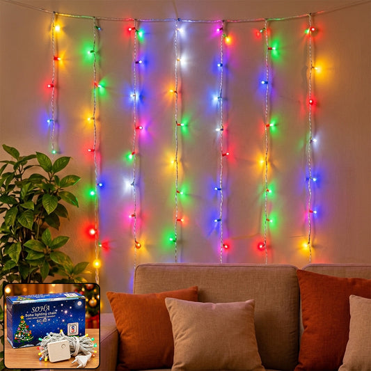 Multicolor LED curtain lights illuminate a living room wall above a sofa with decorative pillows.