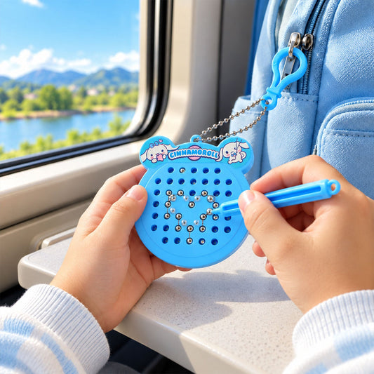 A child's hands hold a blue Cinnamoroll magnetic drawing board, forming a heart shape with beads, on a train.