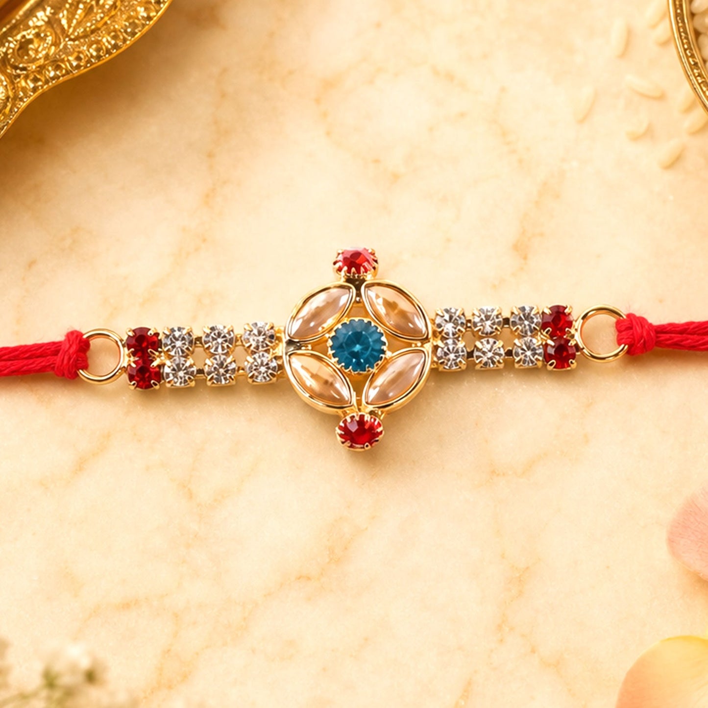 Traditional Rakhi for Brother with oval stone and gold beads on red thread, ideal for Raksha Bandhan.