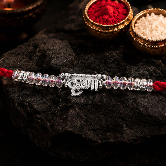 Close-up of Silver Bhaiya Name Rakhi featuring crystal beads and red thread