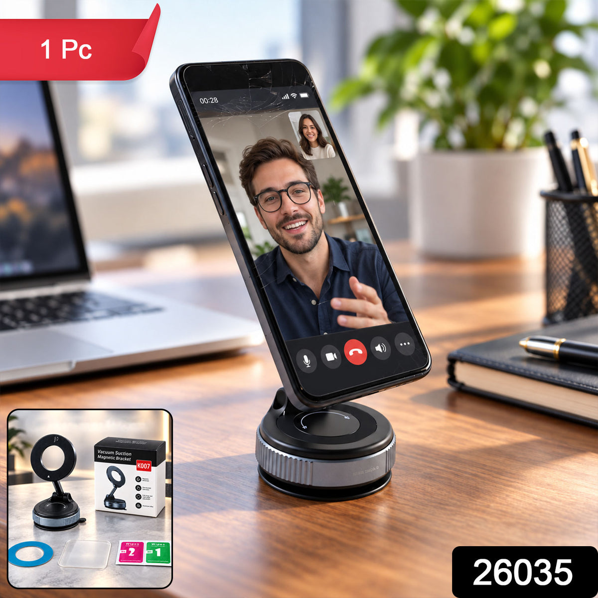 A black smartphone on a gray and black magnetic phone holder on a wooden desk, with a product box in the corner.