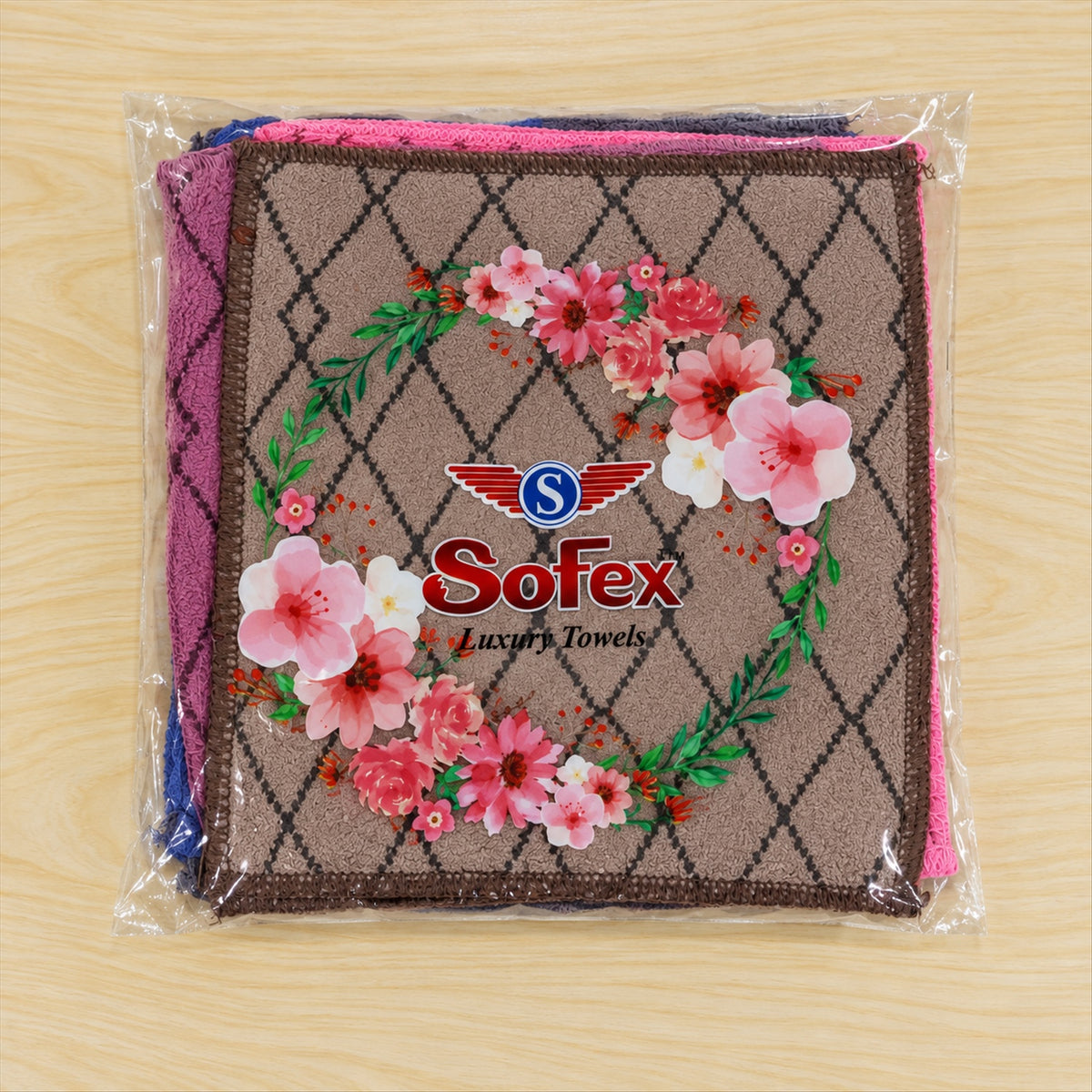 A clear plastic package containing multiple colored handkerchiefs with a diamond pattern, featuring a floral Sofex brand