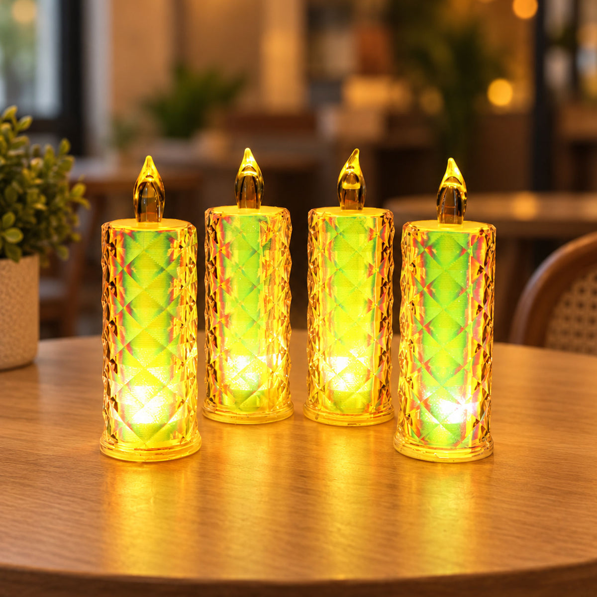 Four illuminated crystal LED candles with a warm yellow glow sit on a wooden table, surrounded by a soft, blurred background.